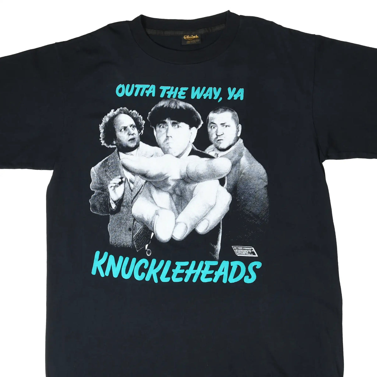 Front of black Three Stooges T-shirt with grayscale trio graphic and turquoise Knuckleheads text