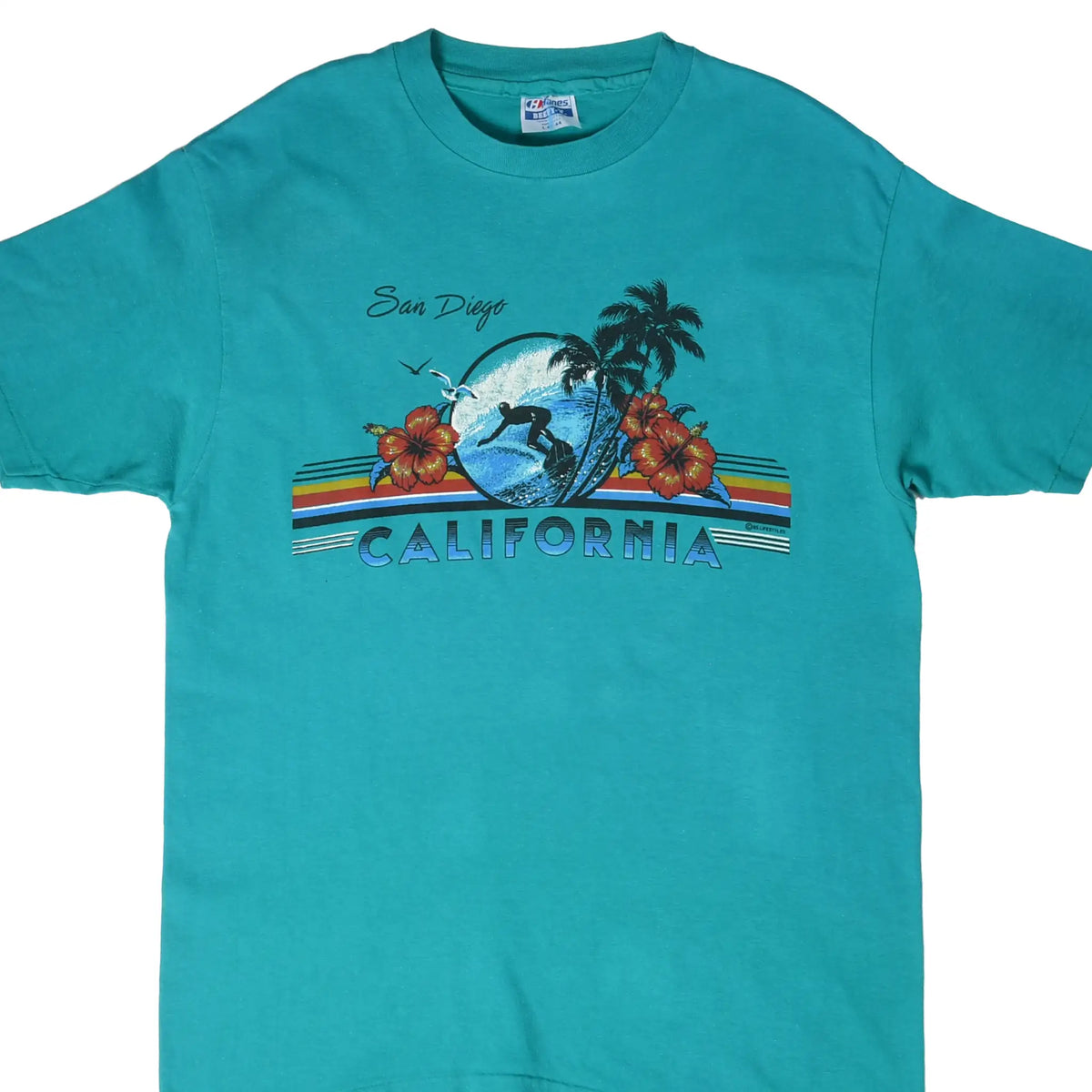 Front of teal San Diego California surf T-shirt with wave, surfer, palms, hibiscus, and striped graphic