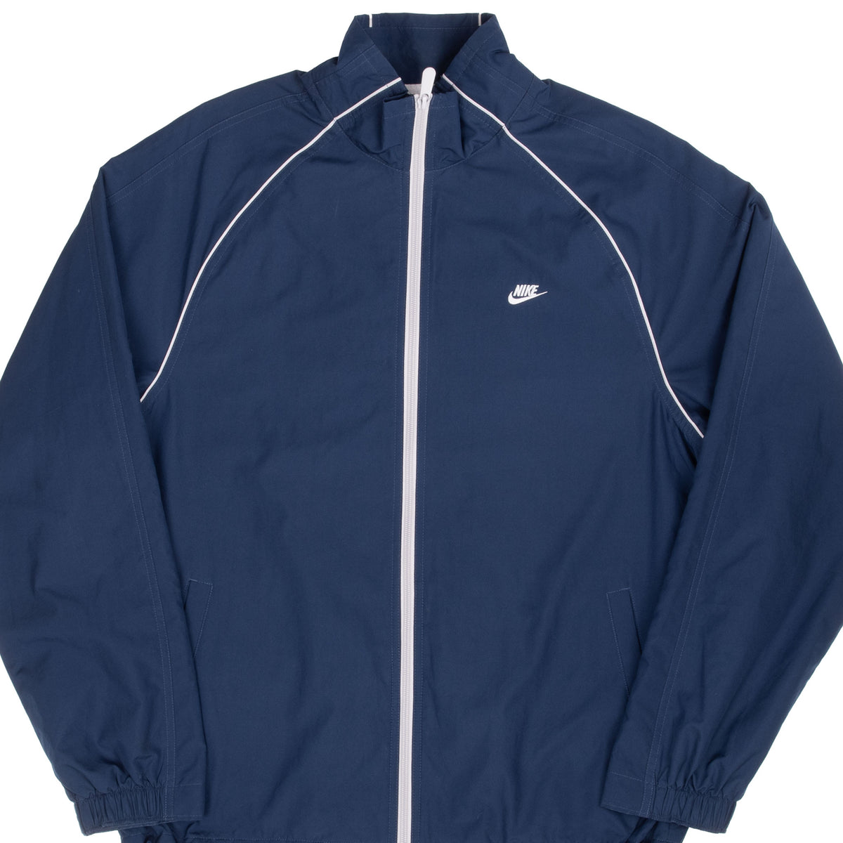Front of navy Nike windbreaker with white zipper, piping and embroidered chest logo