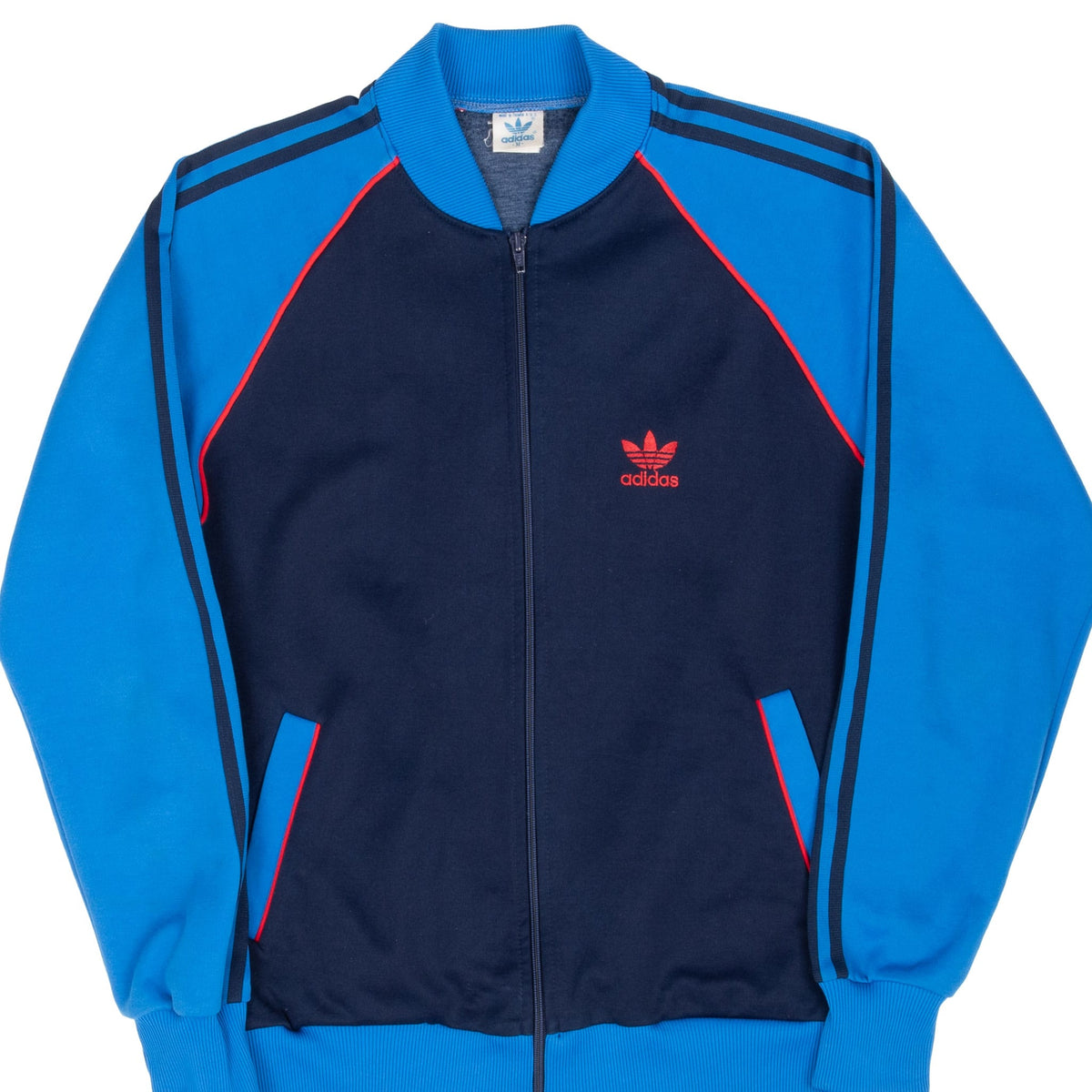 Front of adidas navy and bright blue track jacket with red piping and Trefoil embroidery