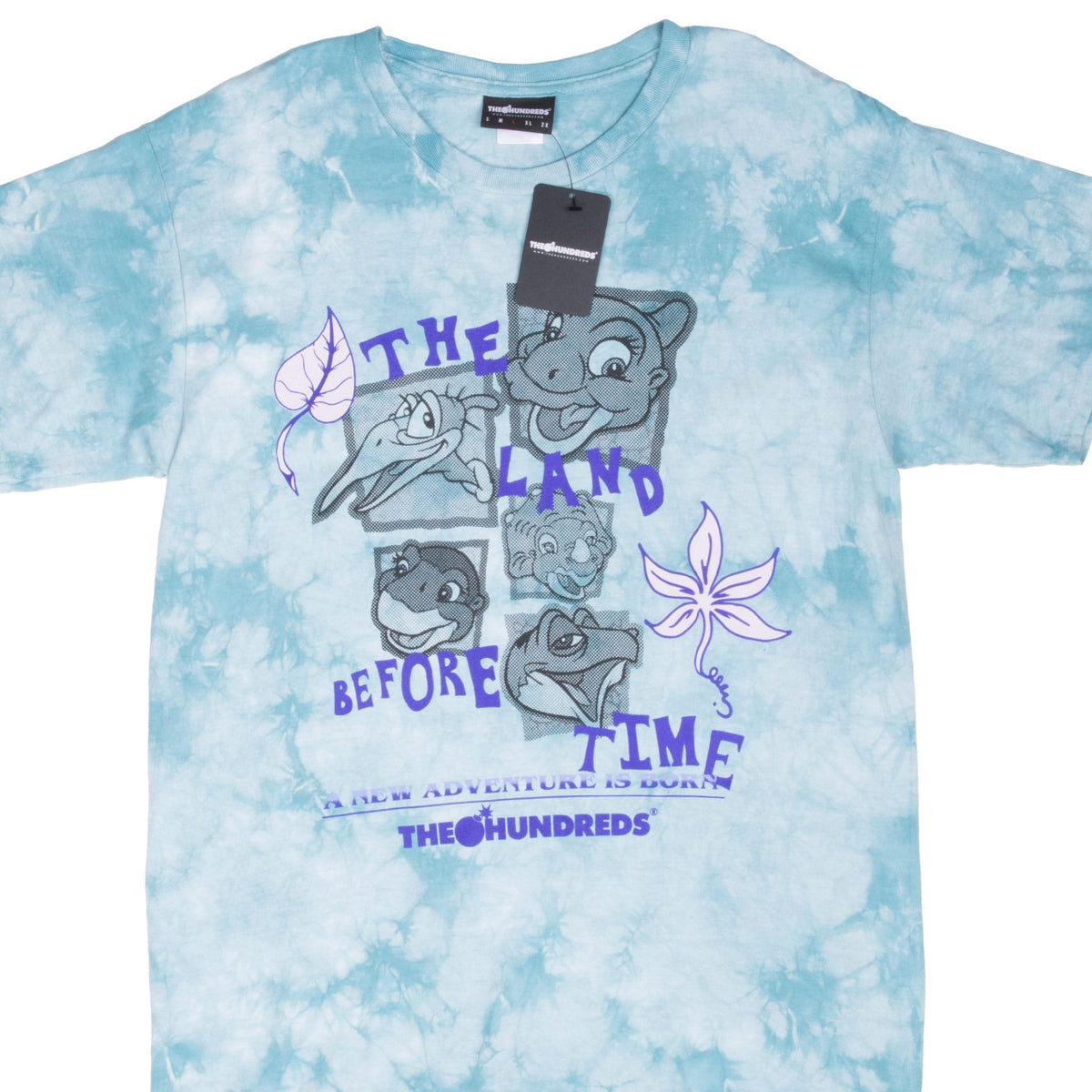 Front upper view of aqua-and-white tie-dye T-shirt with Land Before Time character graphic and hangtag