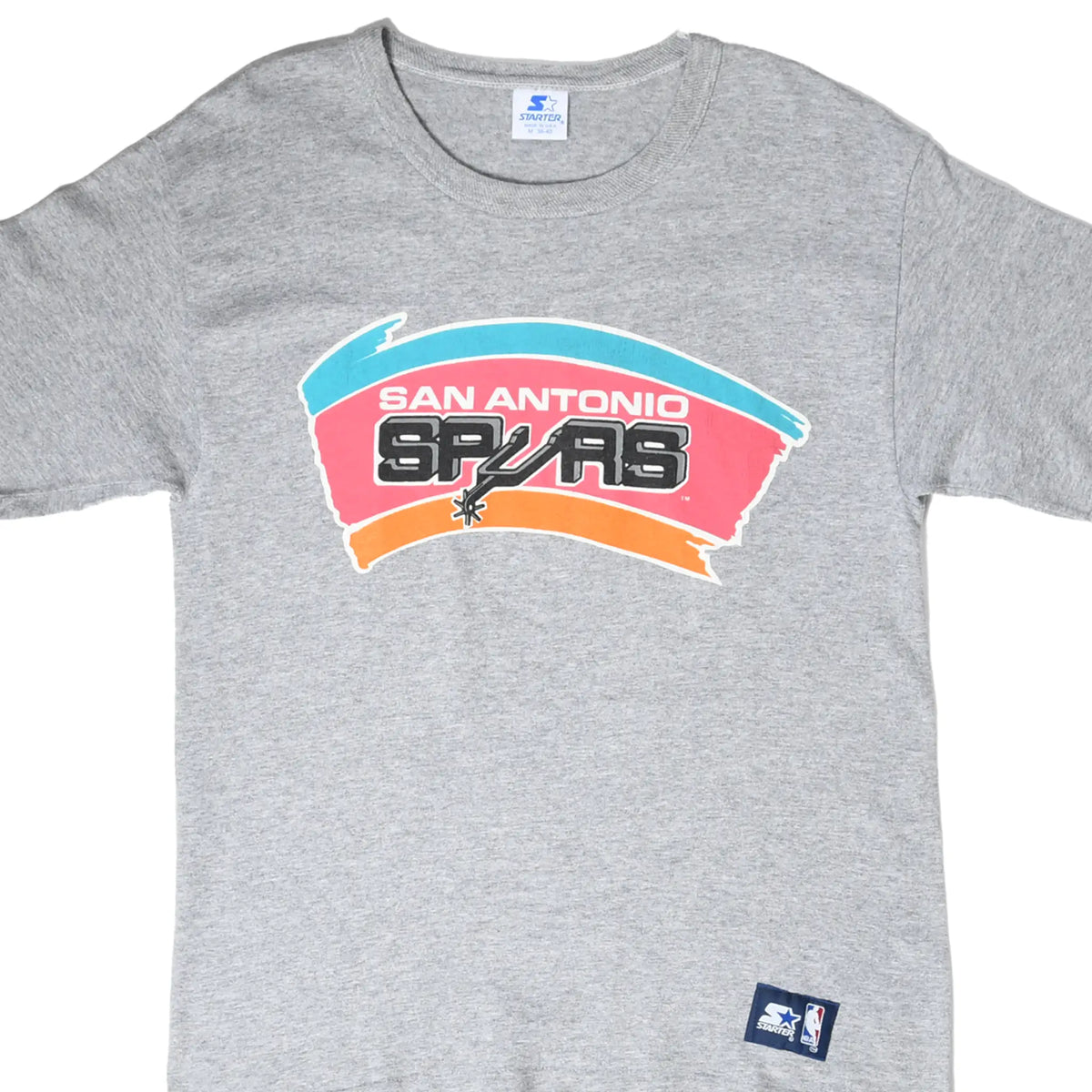 Front detail of gray Starter T-shirt with colorful San Antonio Spurs graphic and NBA hem patch