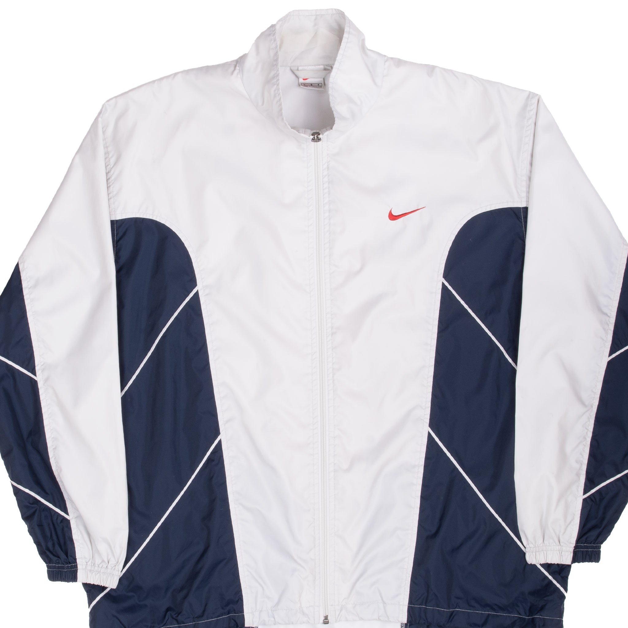 Front view of white and navy Nike windbreaker with red chest Swoosh and diagonal piping