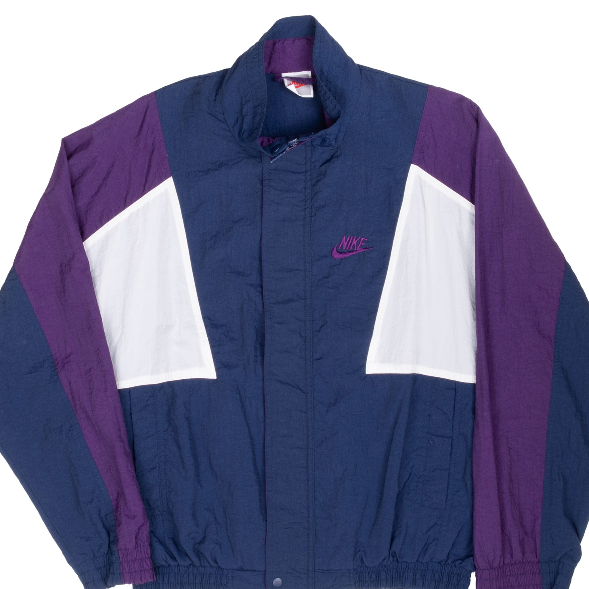 Front detail of blue, purple, and white Nike windbreaker with embroidered chest logo