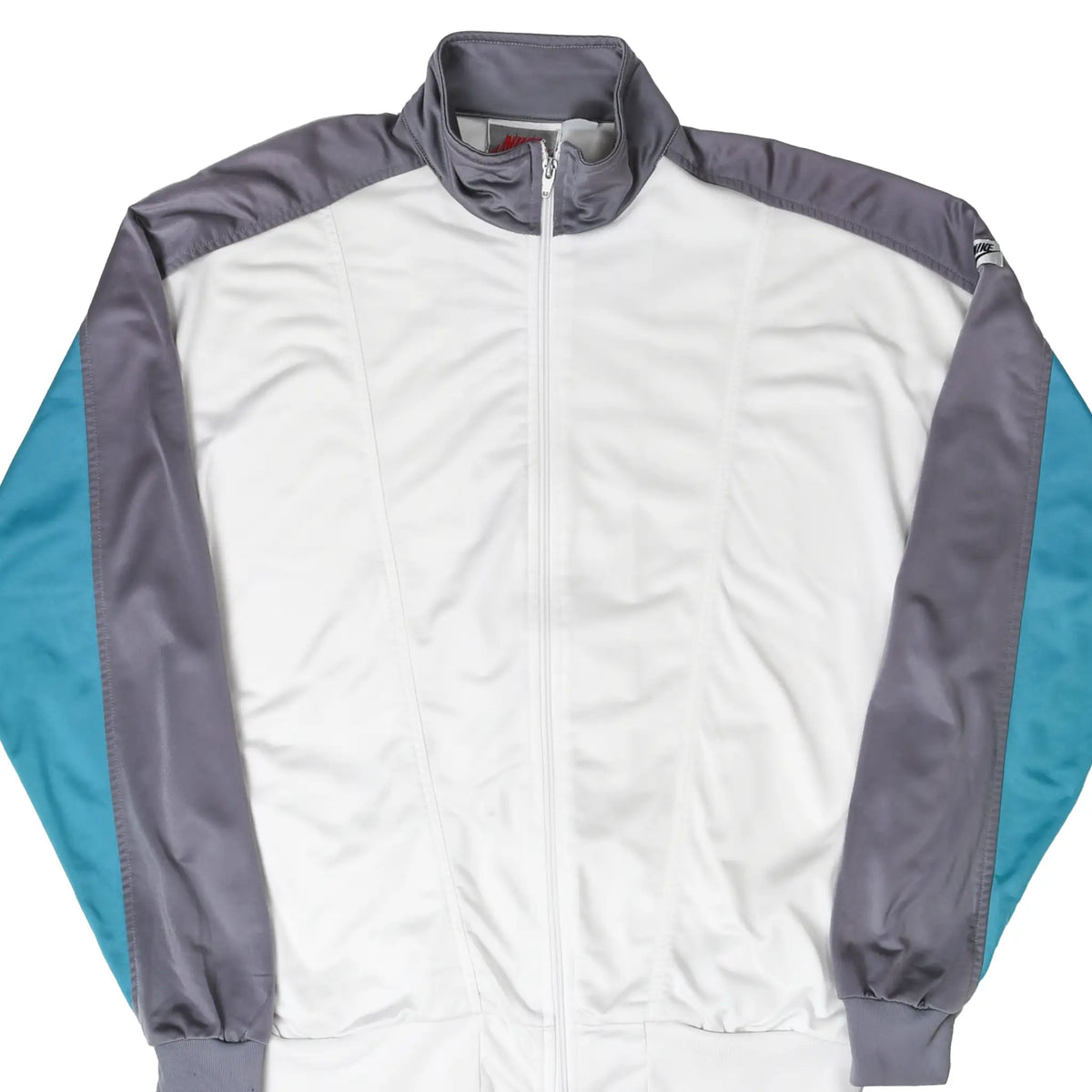 Front of white Nike zip-up tracksuit jacket with gray shoulders and teal sleeve panels