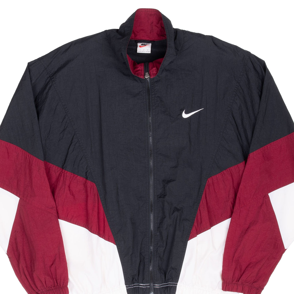 Front upper view of black, burgundy and white Nike windbreaker with embroidered chest Swoosh