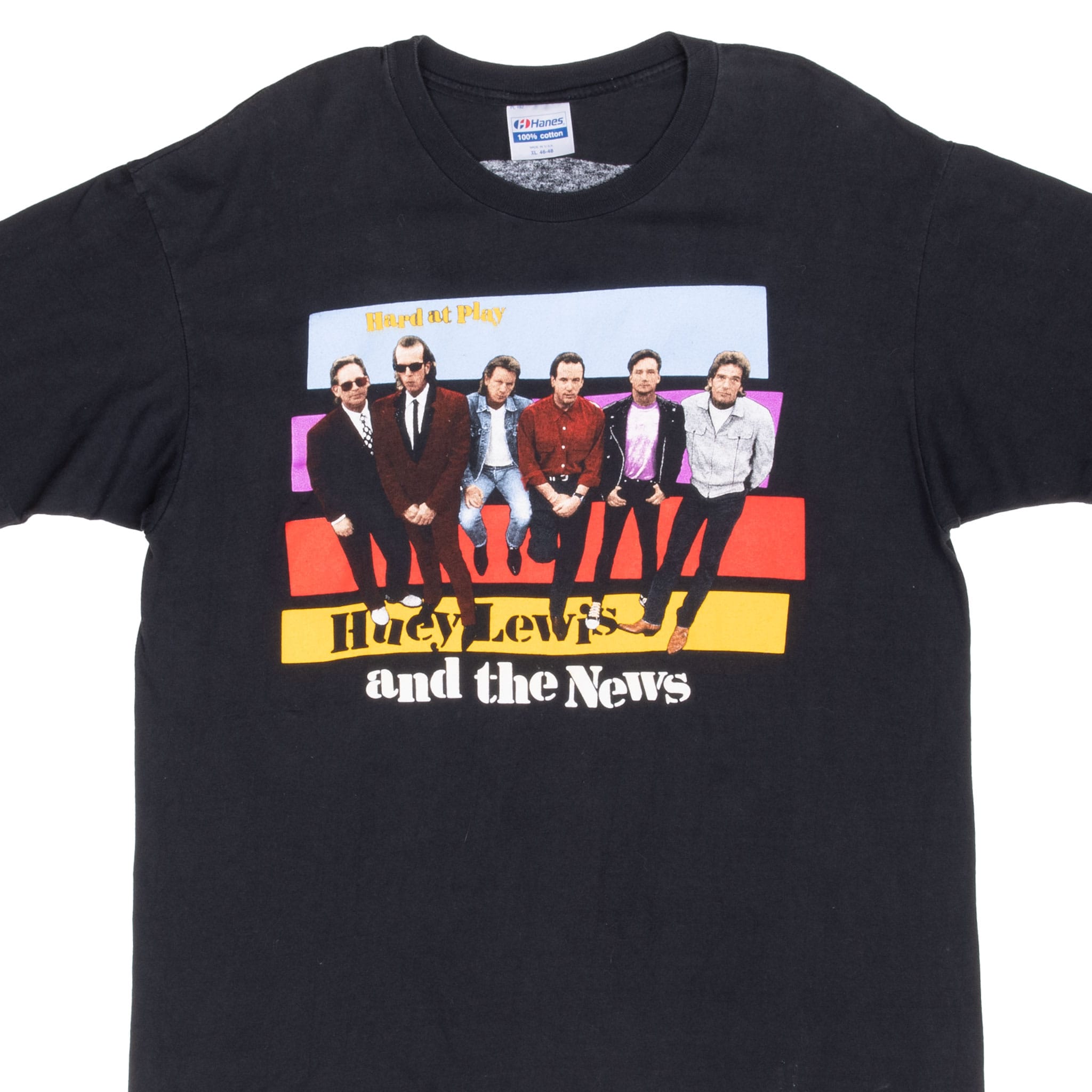 Upper front of black Huey Lewis and the News T-shirt with colorful Hard at Play band graphic