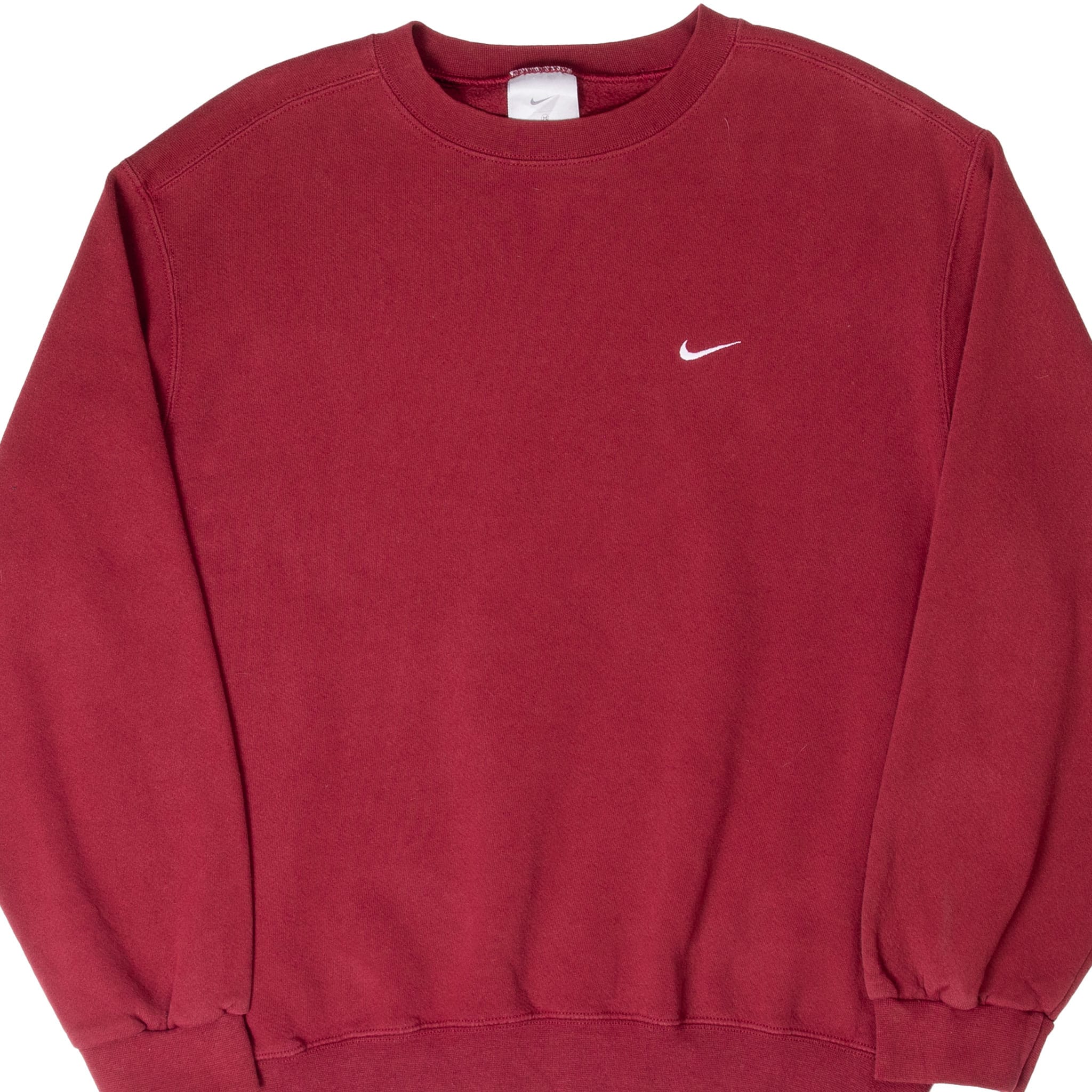 Front of burgundy Nike crewneck sweatshirt with small white embroidered Swoosh