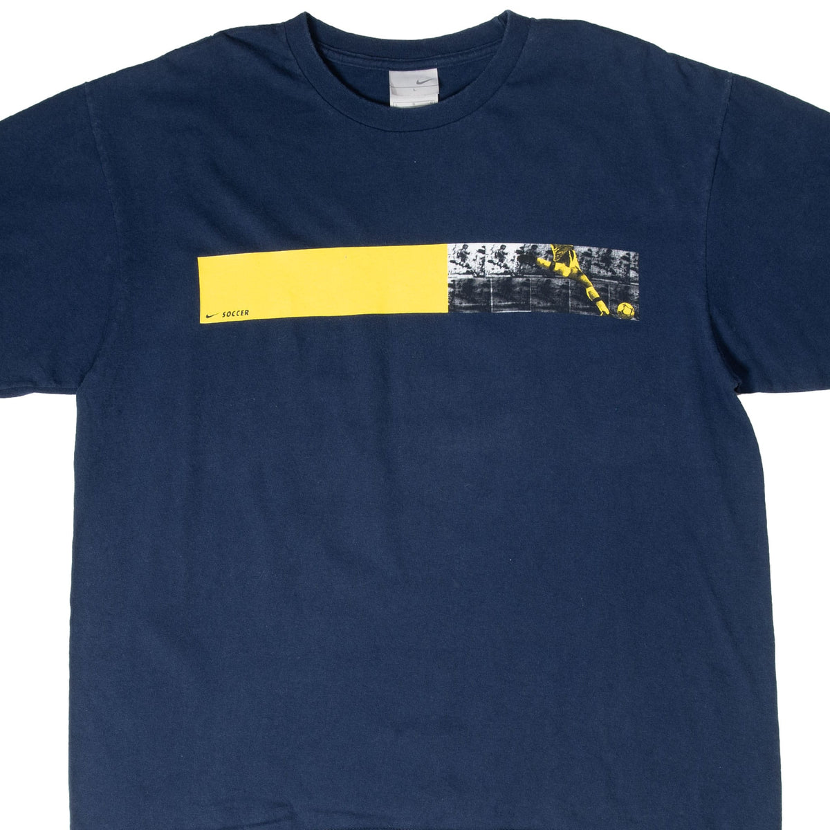 Front of navy Nike soccer T-shirt with yellow and black chest graphic