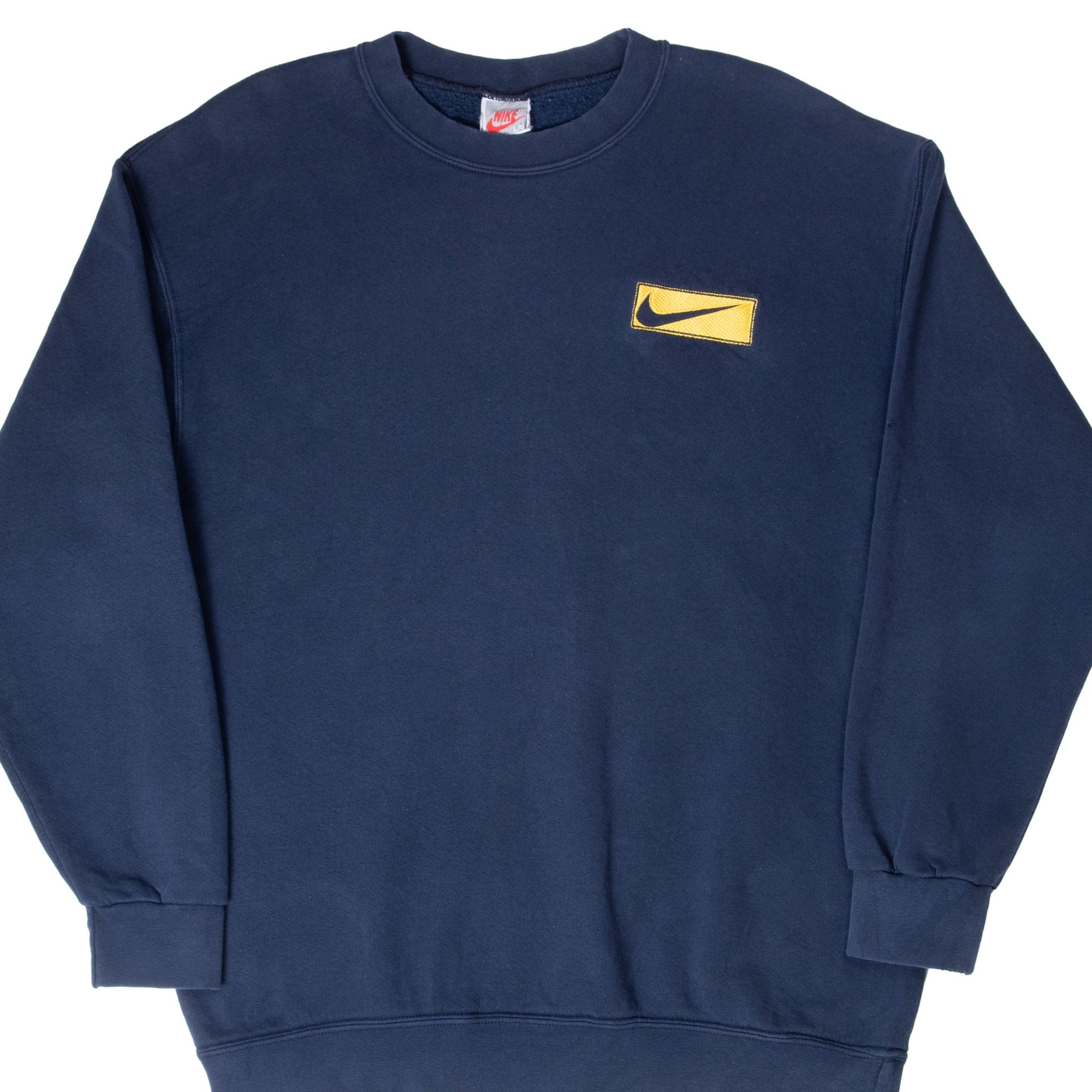 Front close view of navy Nike crewneck sweatshirt with yellow Swoosh chest patch