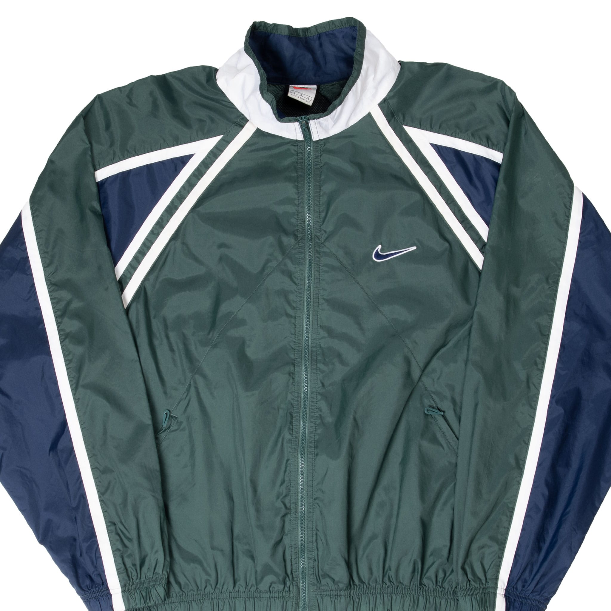 Front view of green Nike windbreaker with navy and white panels and embroidered chest Swoosh