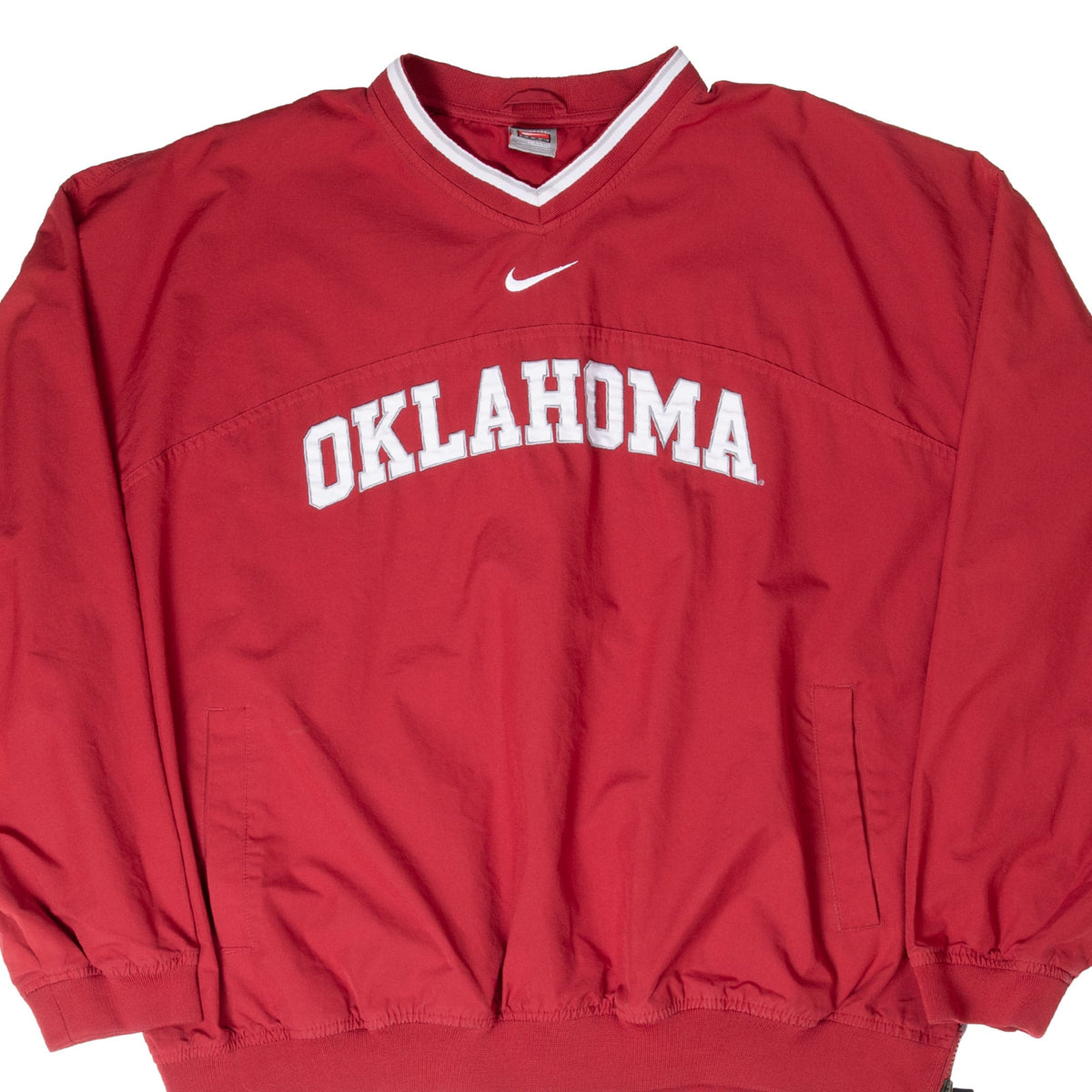 Front of red Nike Oklahoma pullover jacket with white chest lettering and Swoosh