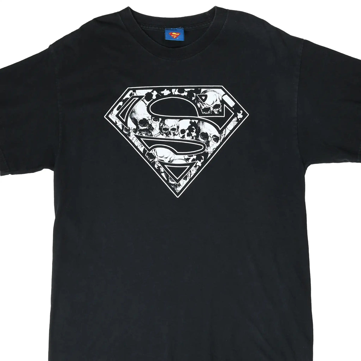 Front of black Superman T-shirt with white skull-filled shield graphic