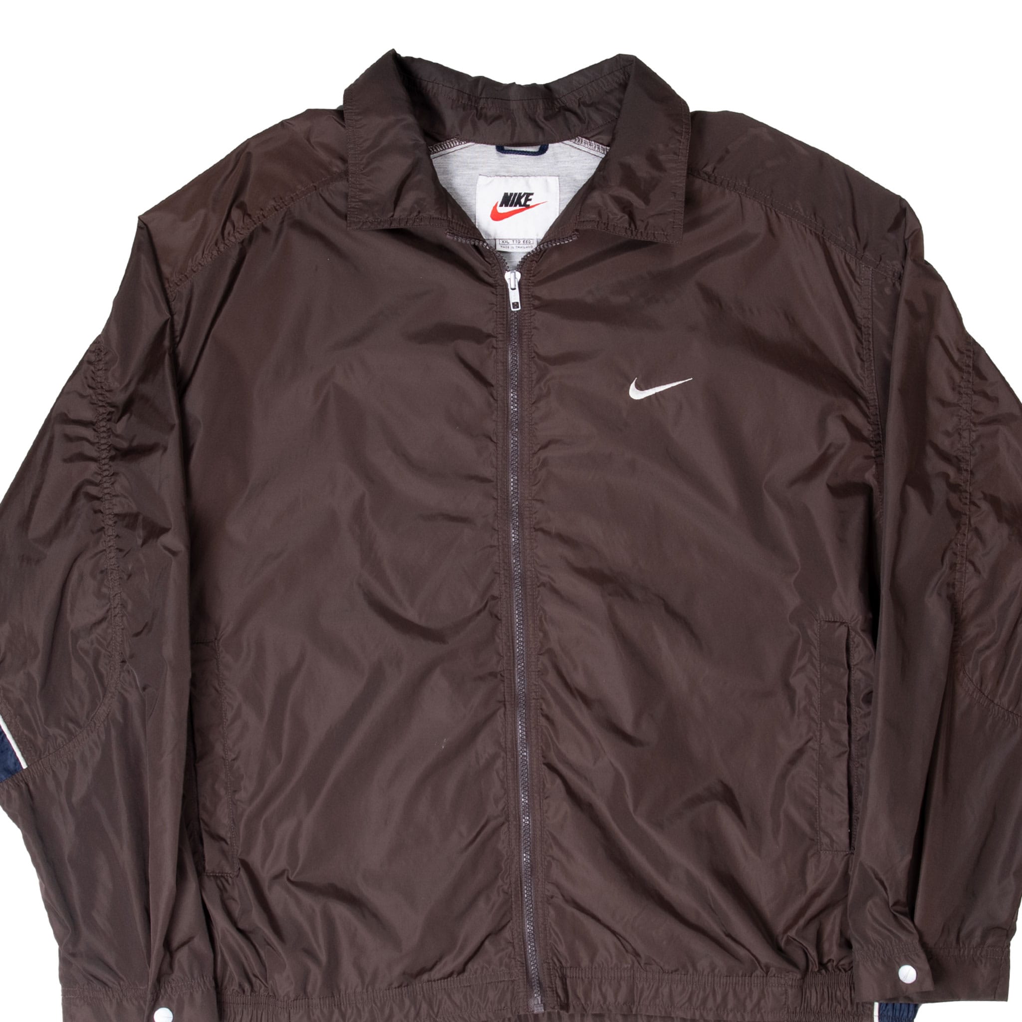 Front close-up of brown Nike windbreaker with full zipper, collar and white embroidered Swoosh