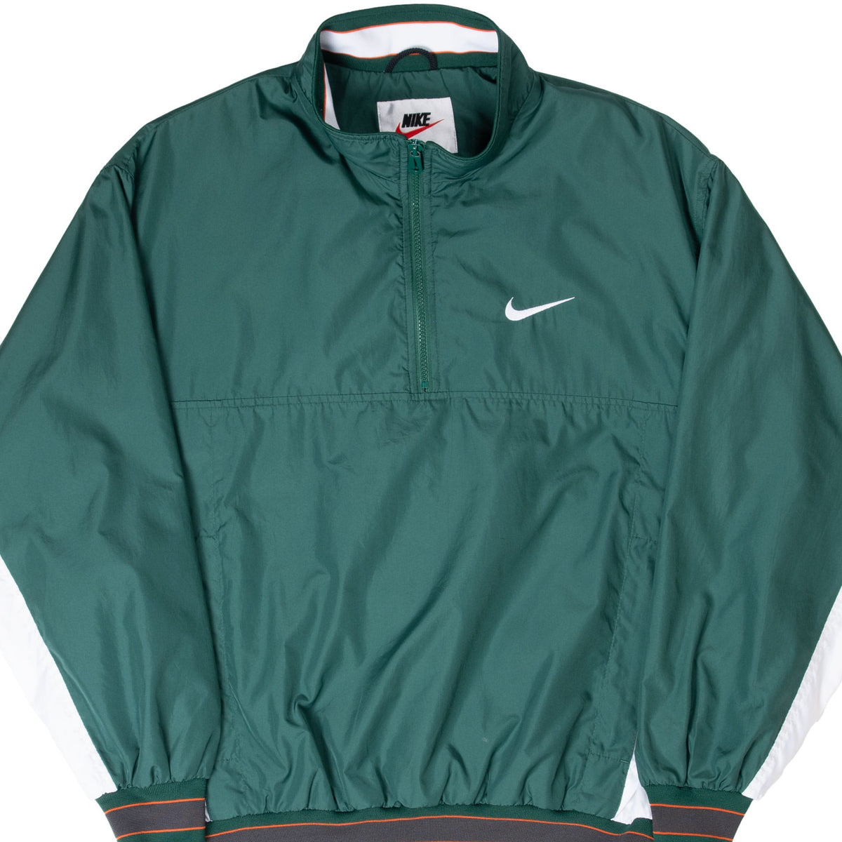 Close front view of green Nike pullover jacket with quarter zip, white Swoosh, and striped ribbed trim