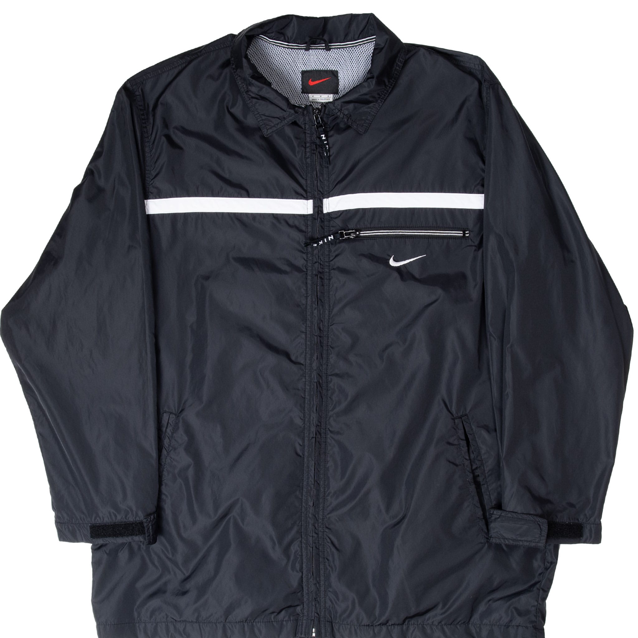 Front of black Nike windbreaker with white chest stripe, zip pocket and embroidered Swoosh
