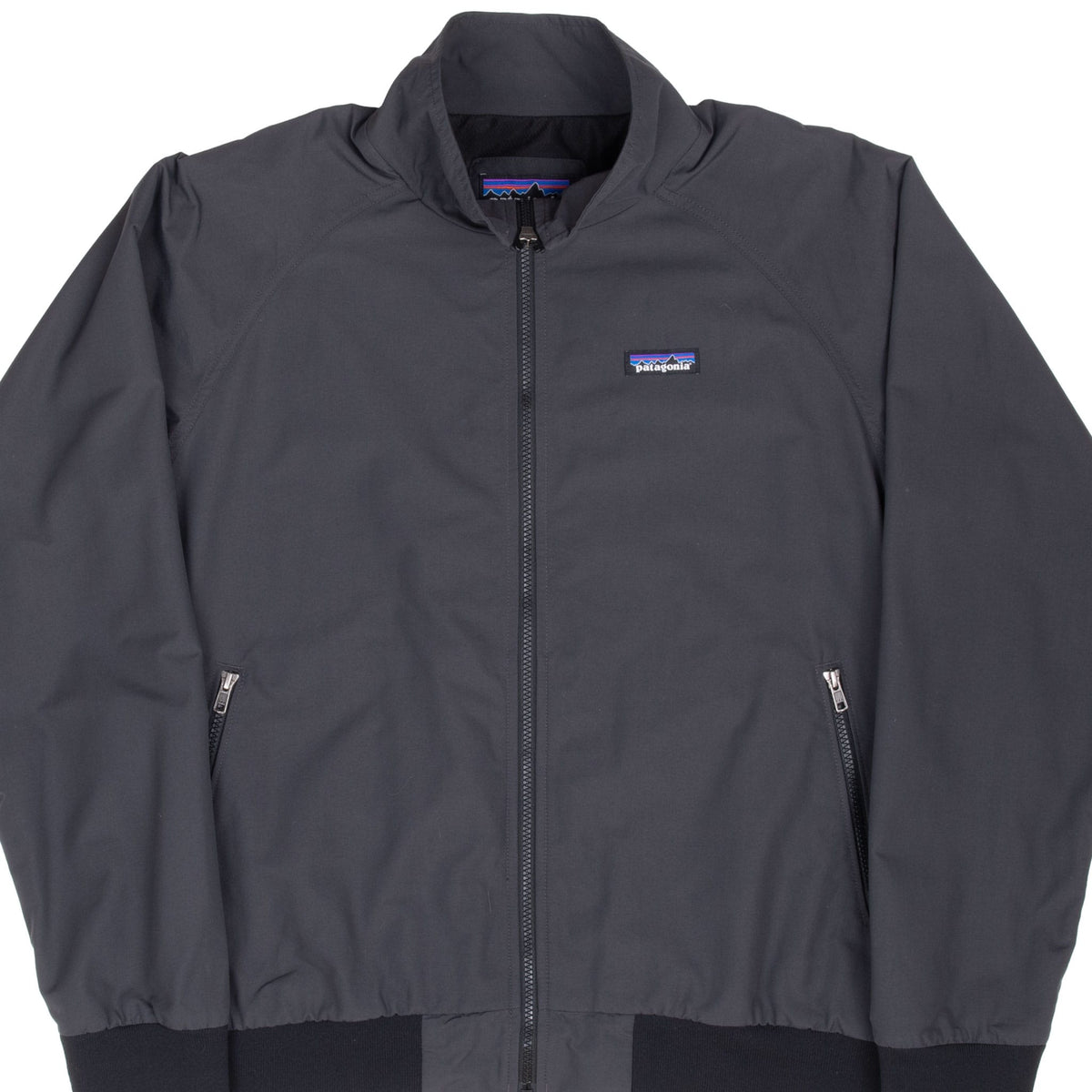 Front close-up of dark grey Patagonia Baggies jacket with full zipper and chest logo patch