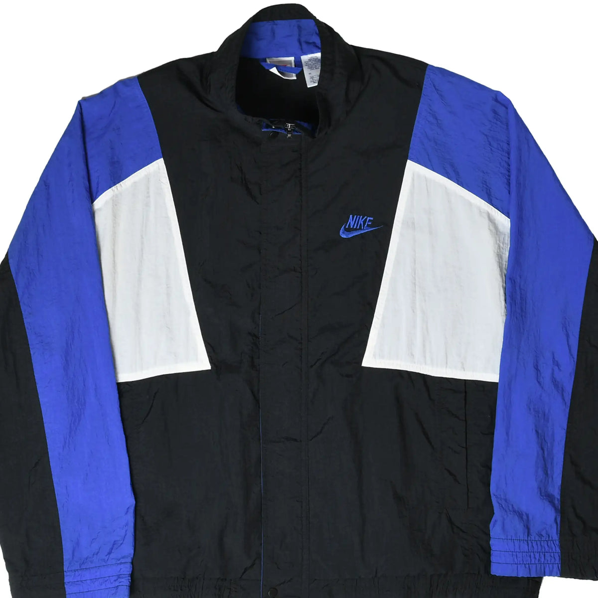 Front close view of black Nike windbreaker with blue sleeves, white panels, and embroidered Swoosh
