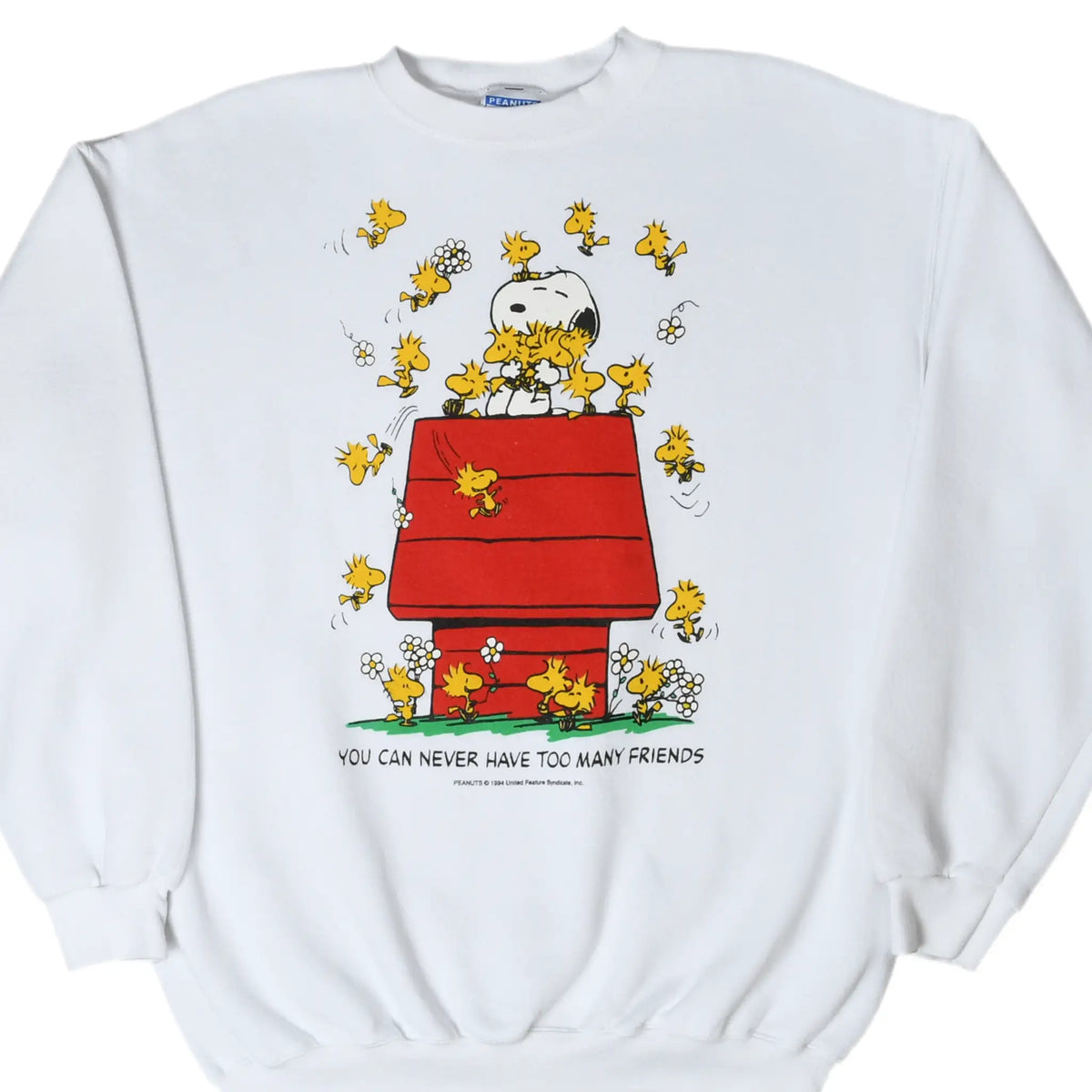 Front of white Peanuts sweatshirt with Snoopy, Woodstock friends, and red doghouse graphic