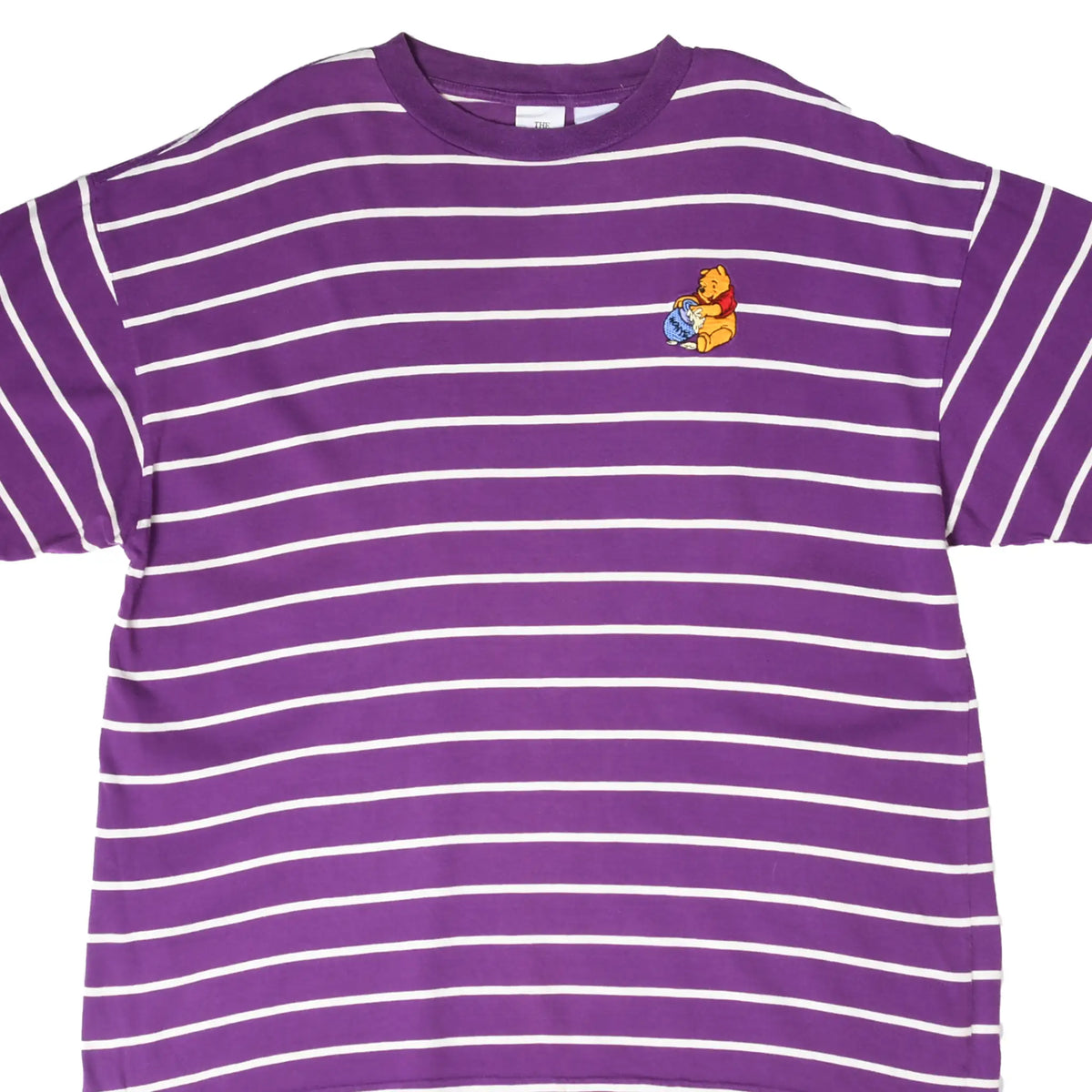 Front close-up of purple and white striped Disney tee with Winnie the Pooh embroidery