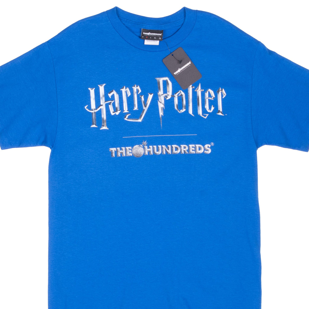 Front of blue The Hundreds x Harry Potter T-shirt with silver-tone chest logo and attached hangtag