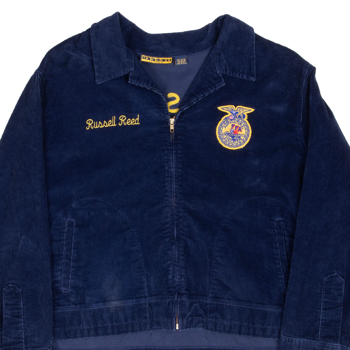 Front upper view of navy FFA corduroy jacket with emblem and Russell Reed chest embroidery