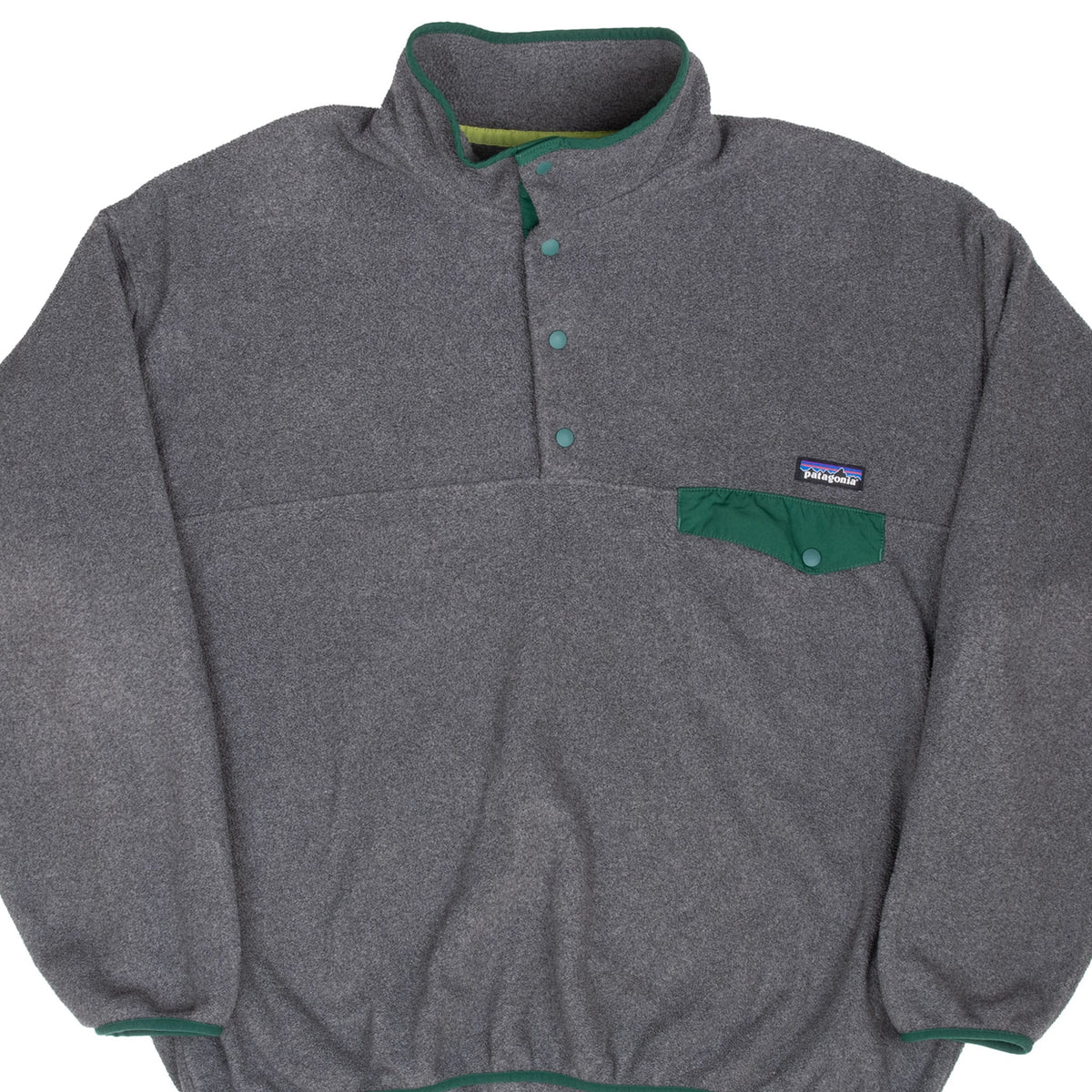 Front detail of Patagonia Snap-T dark grey fleece with green trim and snap-flap chest pocket