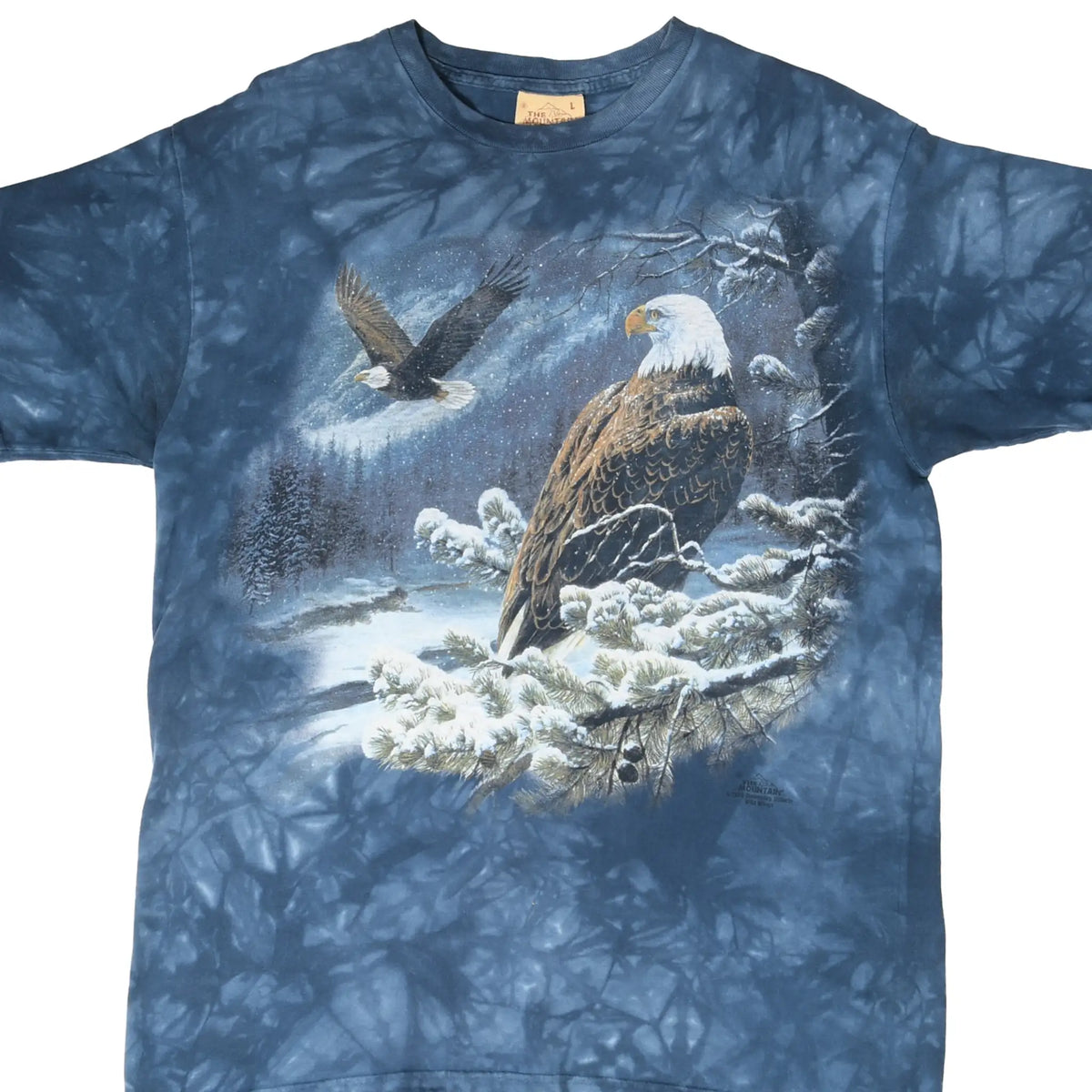 Front of blue tie-dye The Mountain T-shirt with bald eagles in a snowy forest