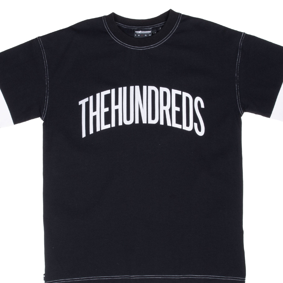 Front close-up of black The Hundreds T-shirt with arched white chest graphic and contrast stitching
