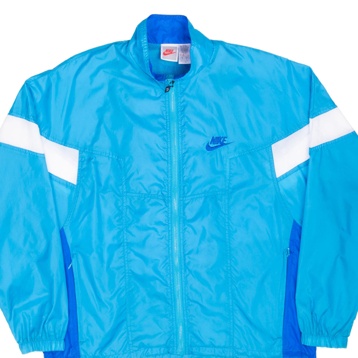 Front of blue Nike windbreaker with white sleeve stripes and embroidered chest logo