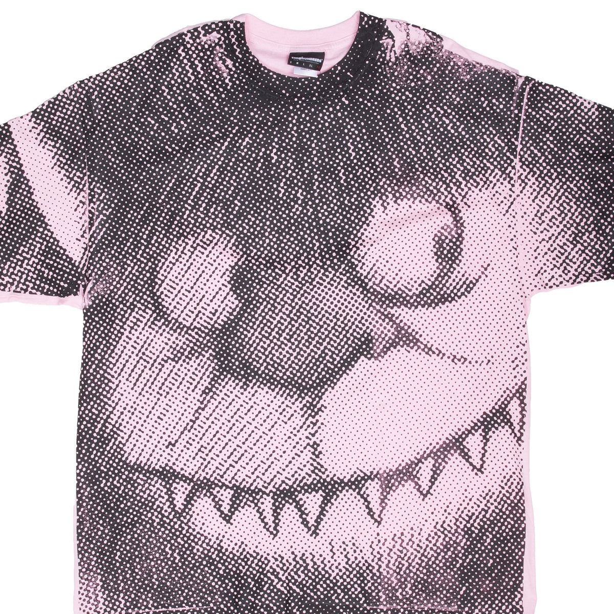 Close-up of black halftone Carol graphic across the front and sleeves of pink T-shirt