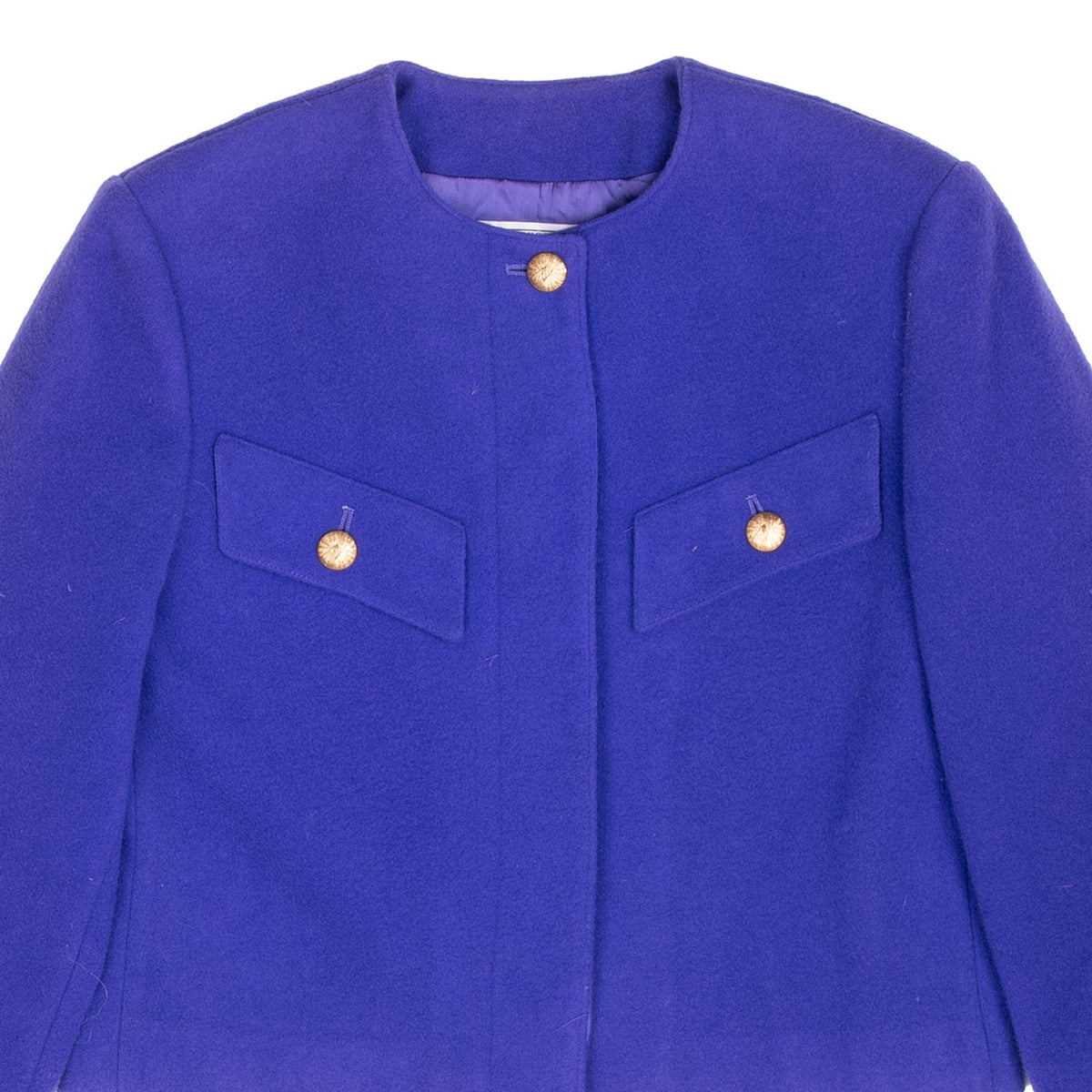 Close-up of purple Pendleton jacket front with collarless neckline, flap pockets and gold-tone buttons