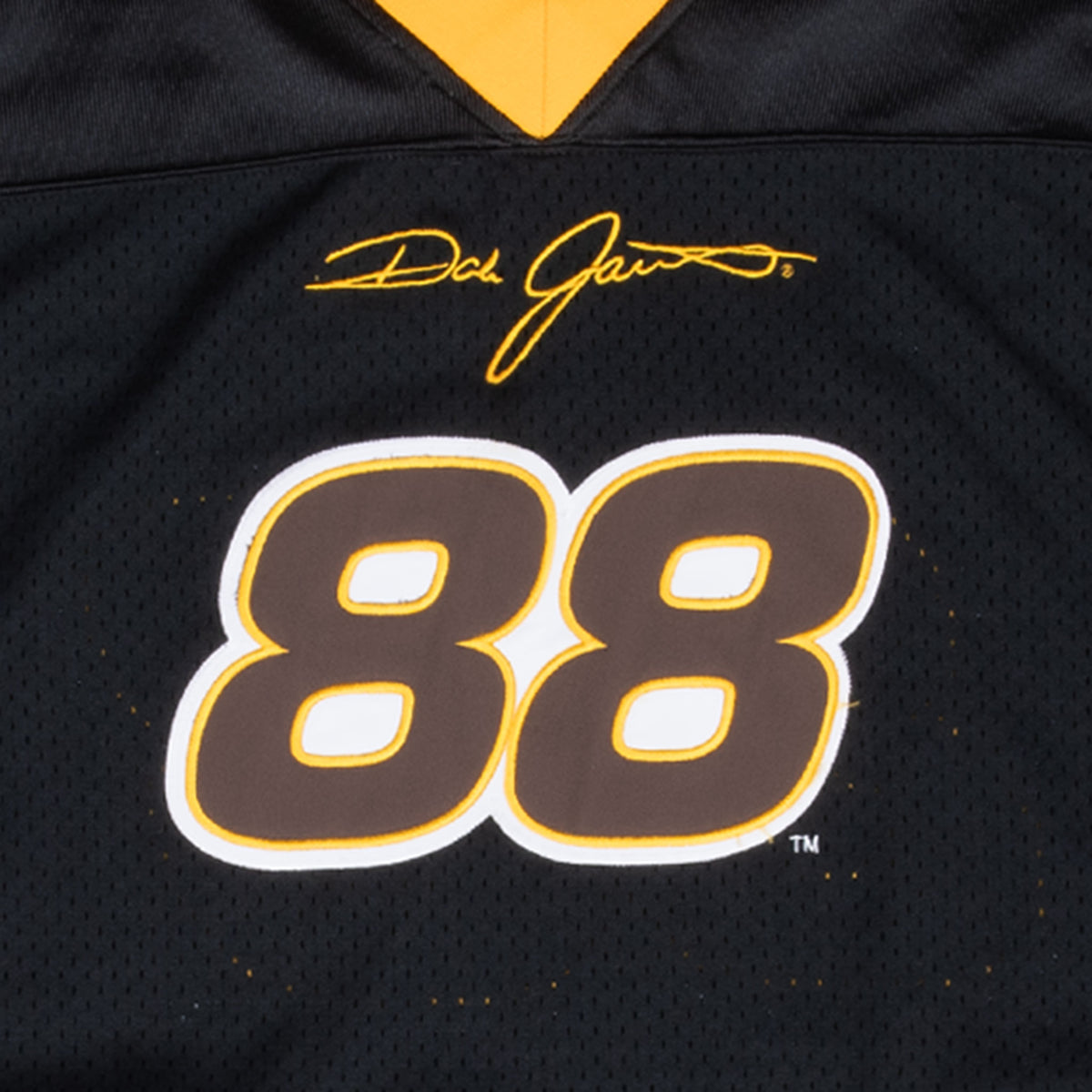 Close-up of Dale Jarrett signature and number 88 graphic on black jersey front