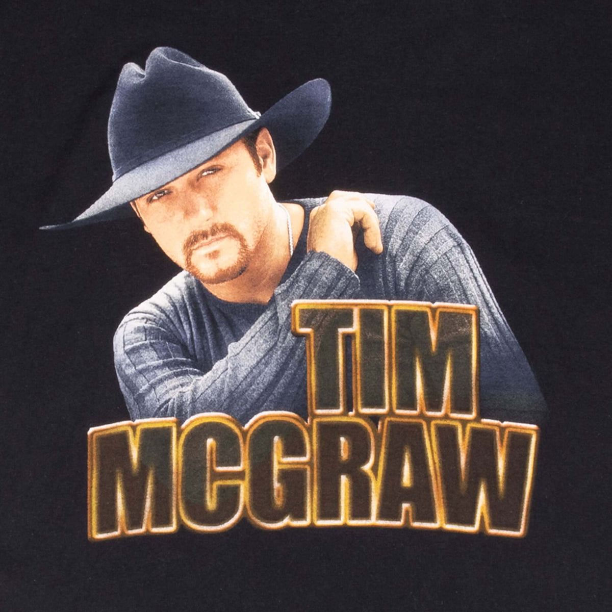 Close-up of Tim McGraw portrait and orange outlined name print on front