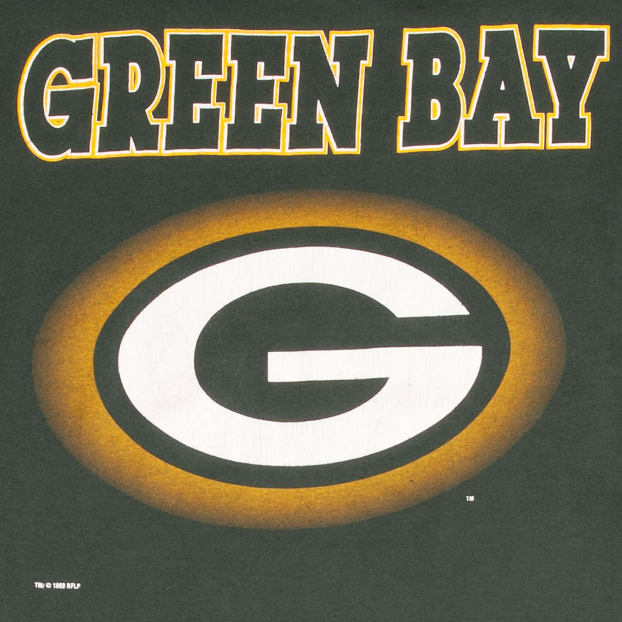 Close-up of Green Bay lettering and Packers G logo graphic on dark green fabric