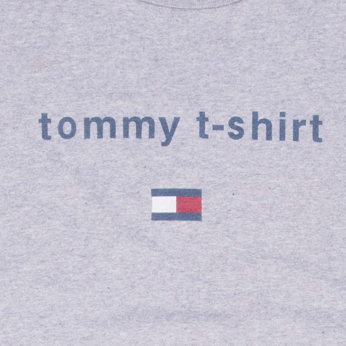 Close-up of blue tommy t-shirt text and red, white and blue flag graphic