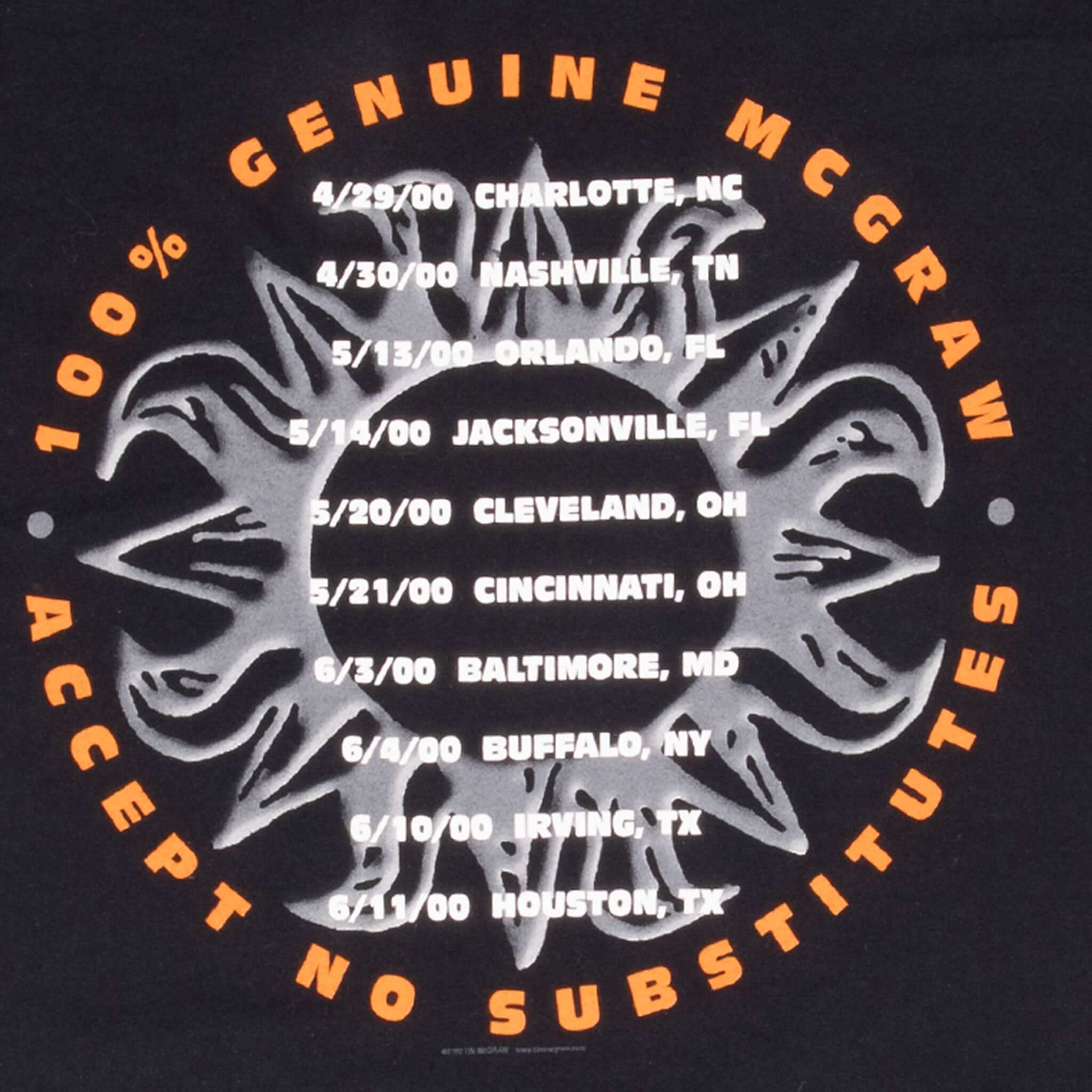 Close-up of Tim McGraw 2000 tour dates printed in white within an orange circular slogan
