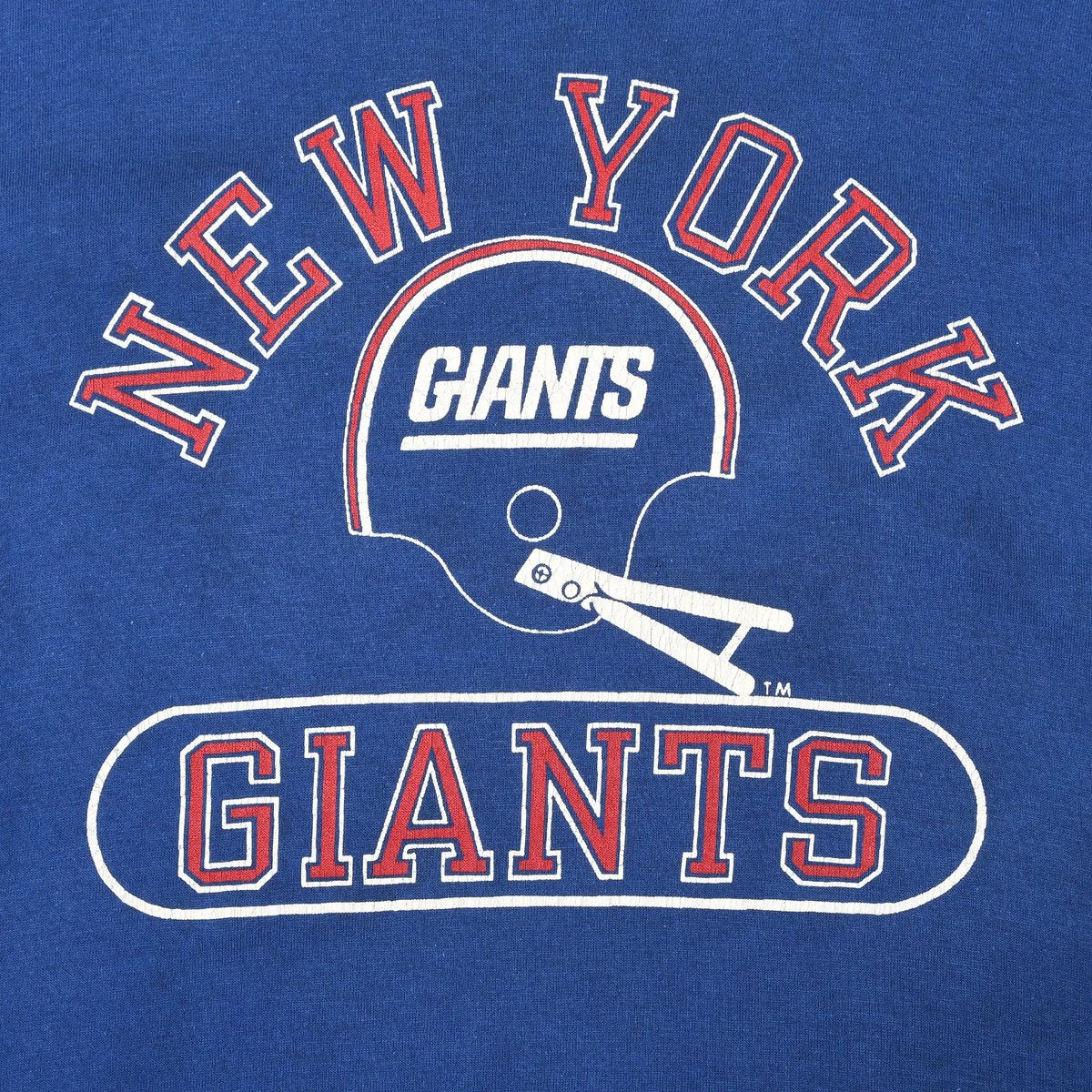 Close-up of New York Giants helmet graphic and red-and-white lettering on blue shirt