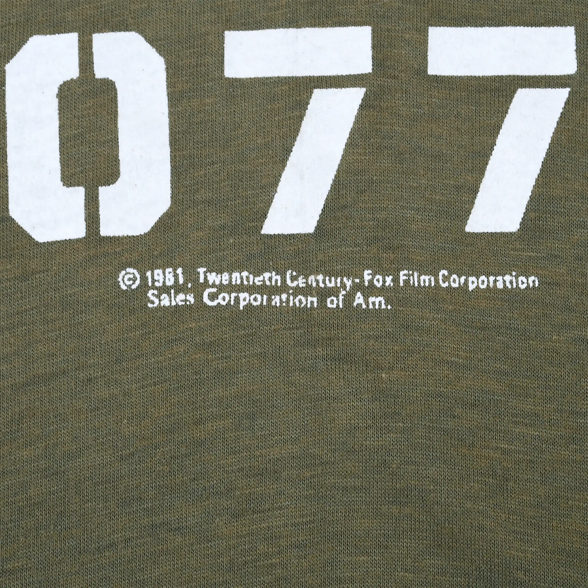 Close-up of 1981 copyright text beneath the white 4077th print
