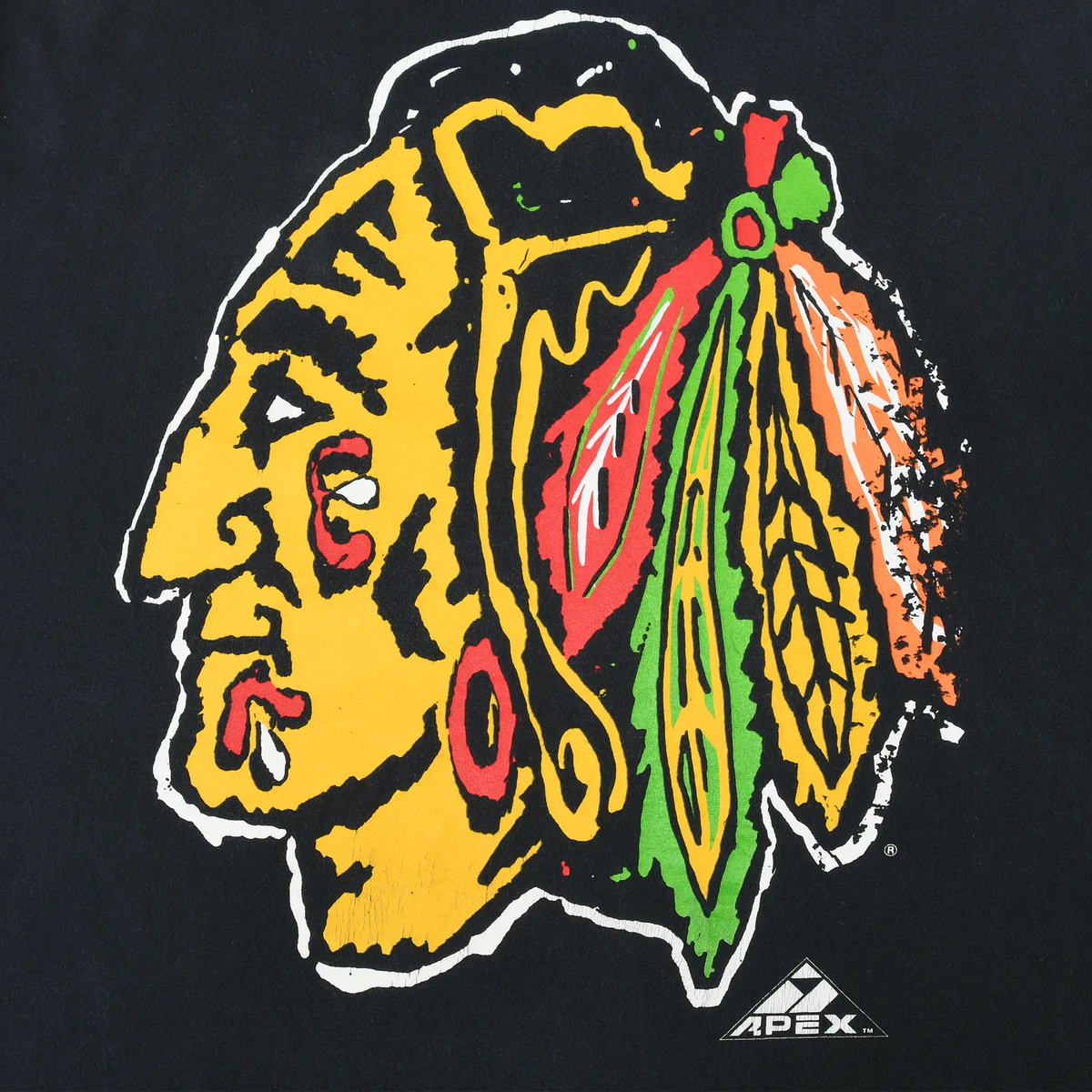 Close-up of multicolor Chicago Blackhawks team logo and Apex mark on back of black T-shirt