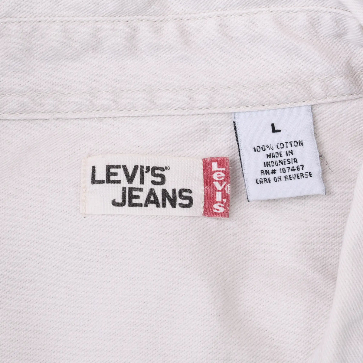 Levi's Jeans neck label and size large care tag inside white denim shirt