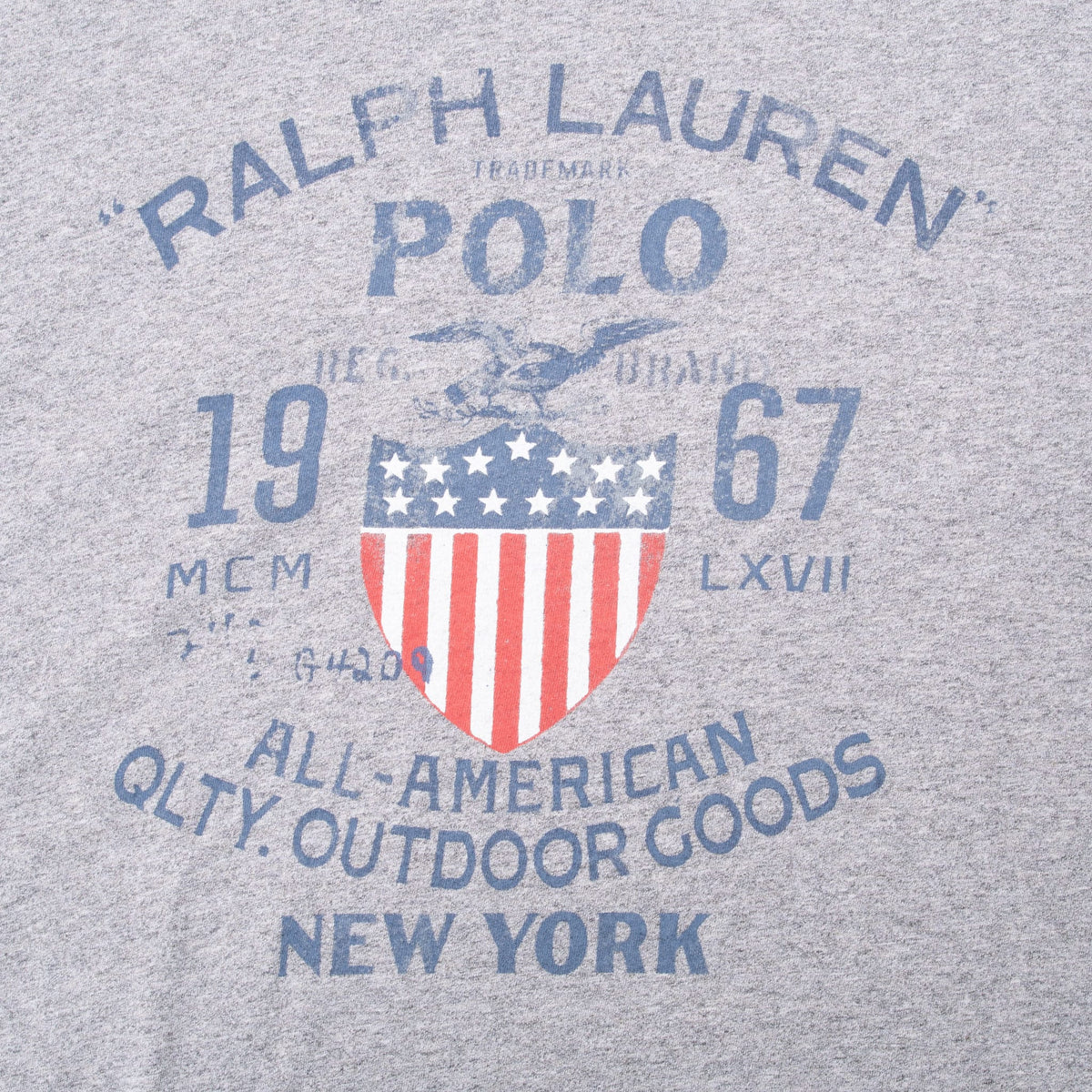 Close-up of Ralph Lauren Polo New York shield graphic on grey T-shirt
