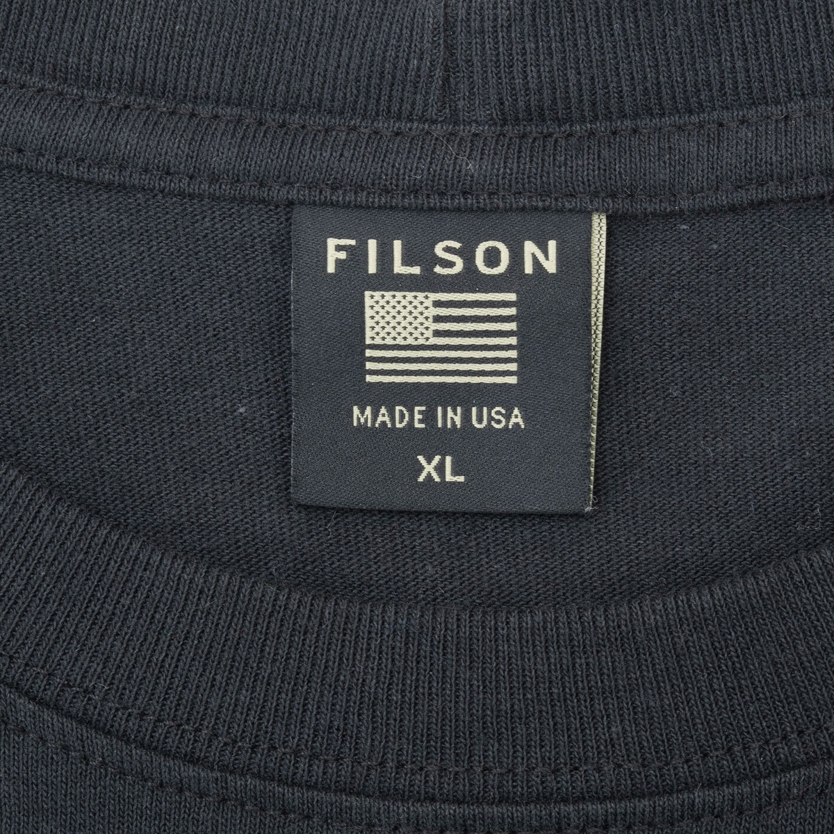 Filson XL neck tag with American flag and Made in USA text