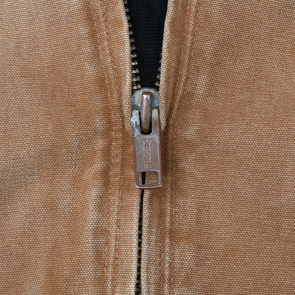 Close-up of metal front zipper on brown Carhartt jacket