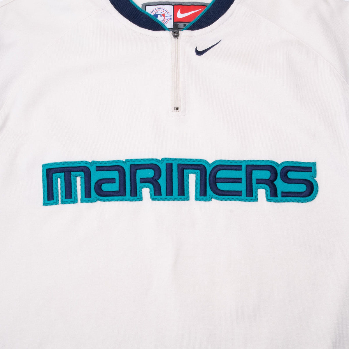 Embroidered Mariners chest lettering, Nike Swoosh and quarter-zip neckline