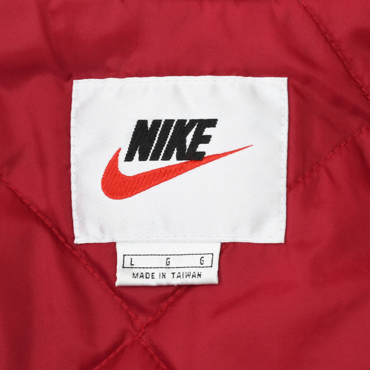Nike logo and size large label on red quilted jacket lining