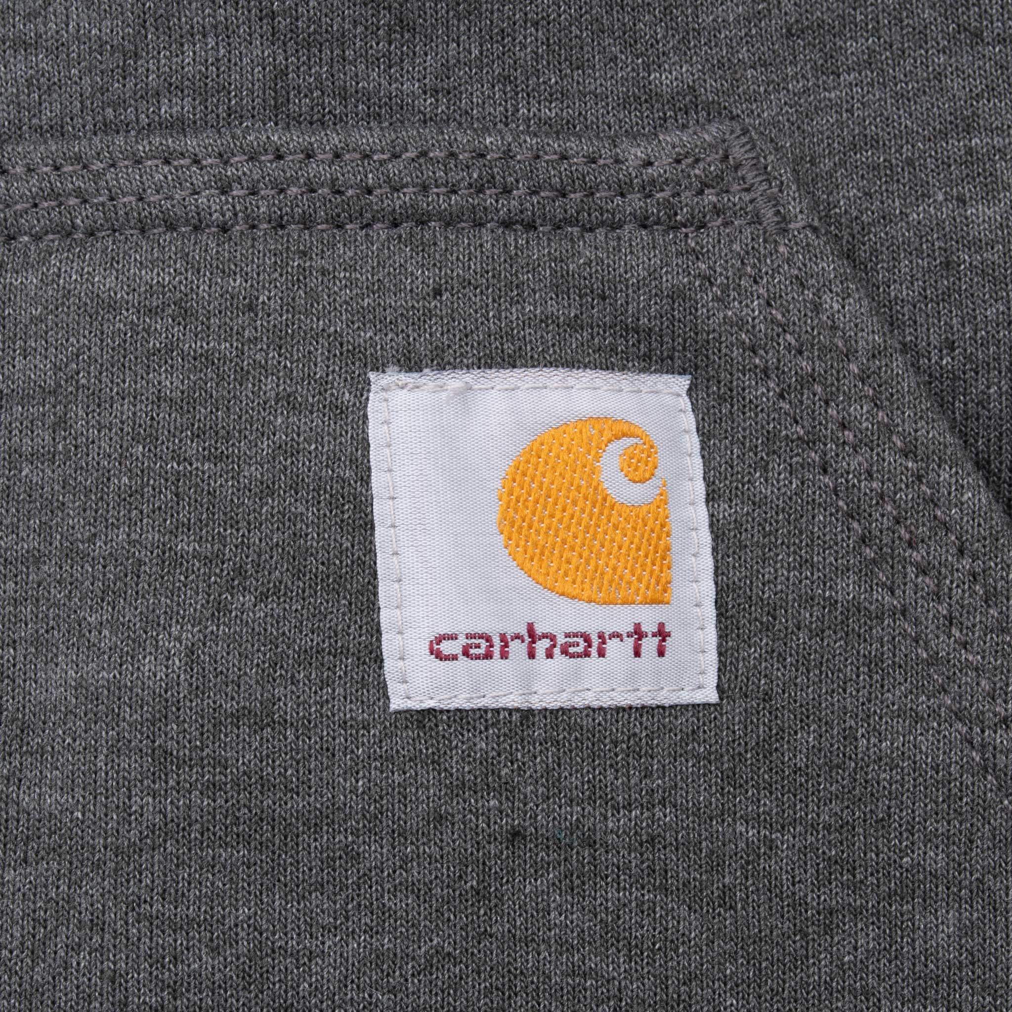 Close-up of Carhartt logo patch on the dark grey hoodie pocket