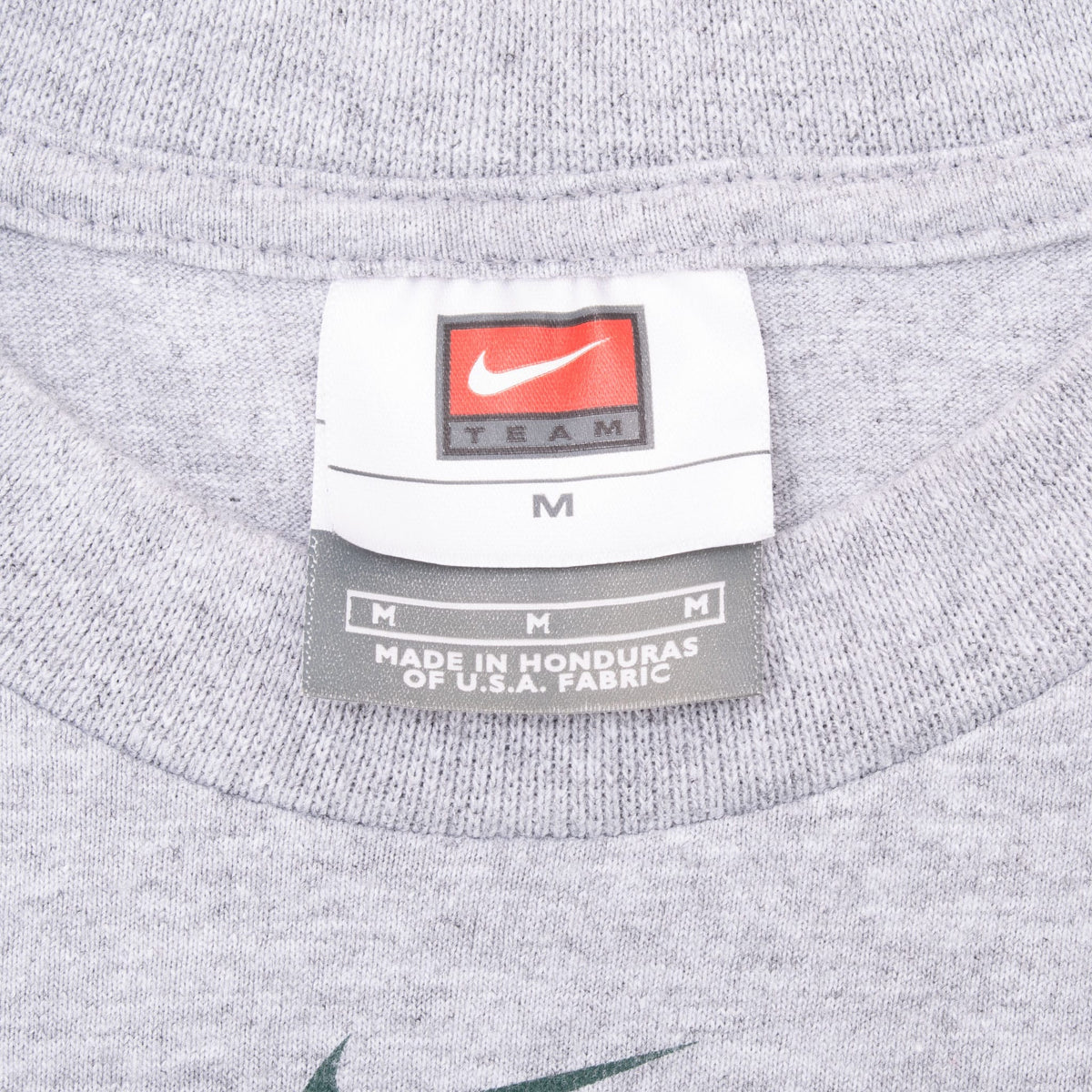 Close-up of Nike Team medium neck tag inside gray Oregon T-shirt