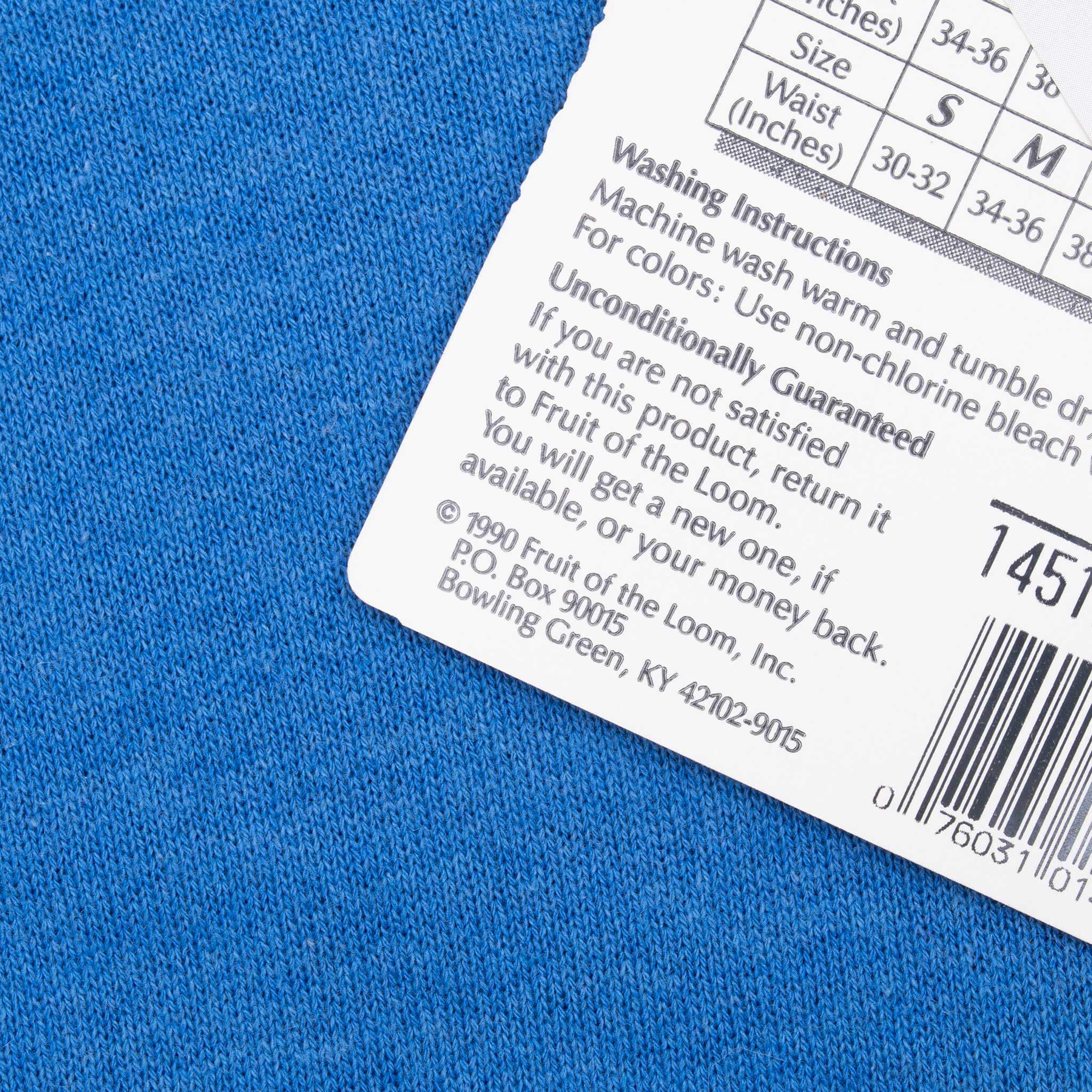 Close-up of Fruit of the Loom retail tag with washing instructions and barcode