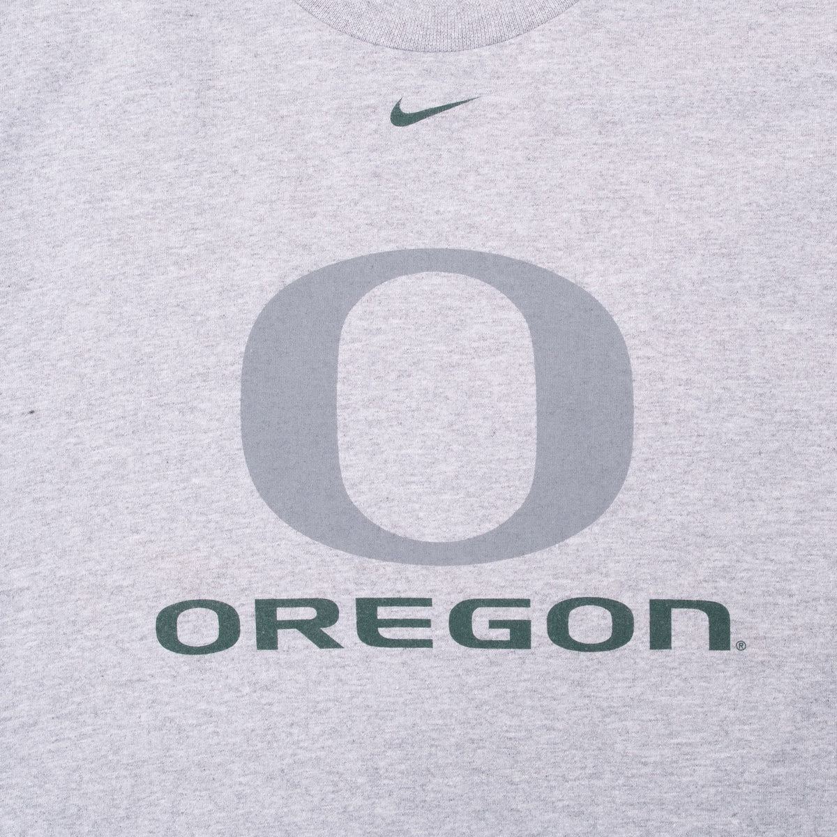 Close-up of front Nike swoosh, gray O logo, and green Oregon print